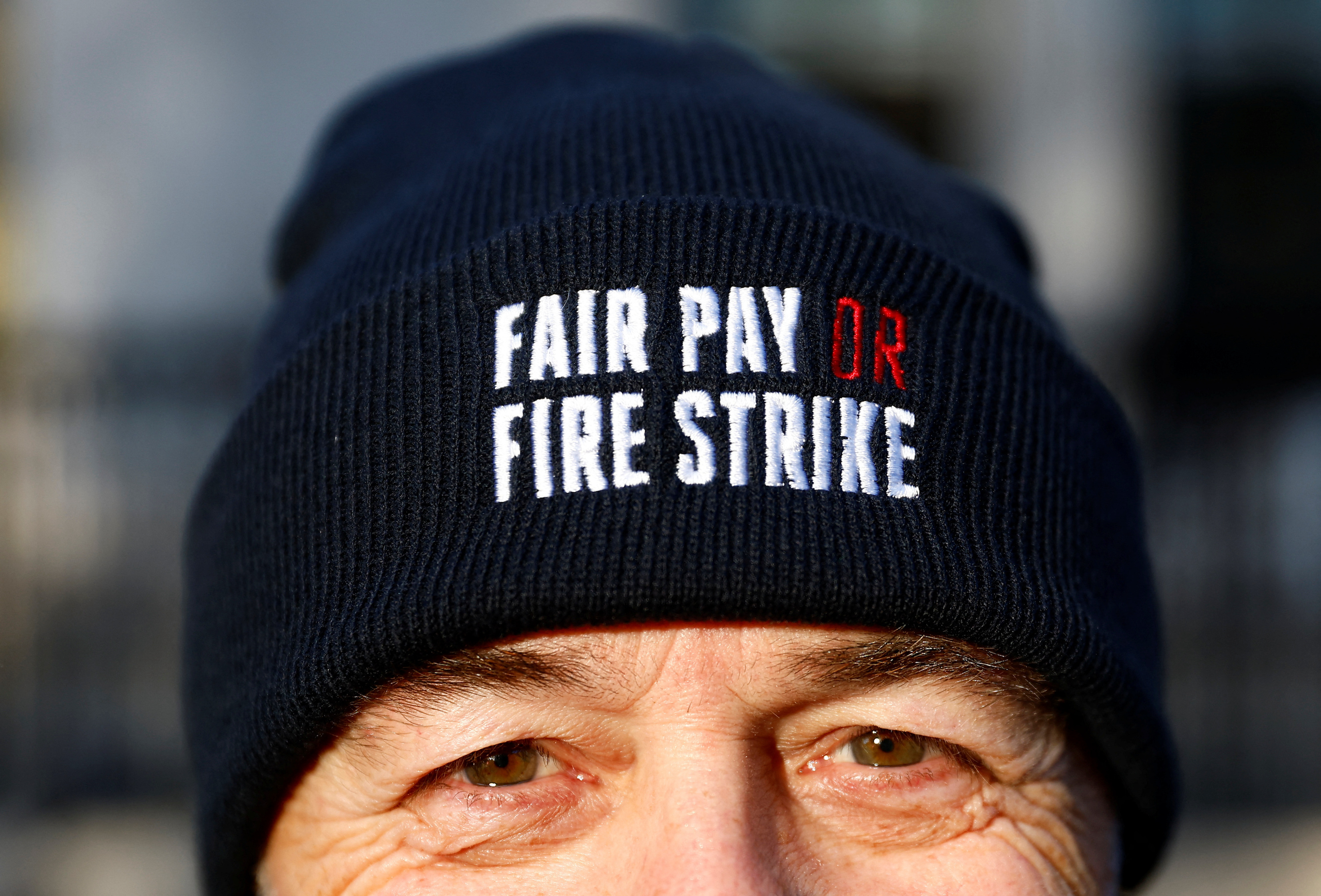 A members of the Fire Brigades Union takes part in a rally regarding possible future strike action linked to a pay dispute, in London, Britain.