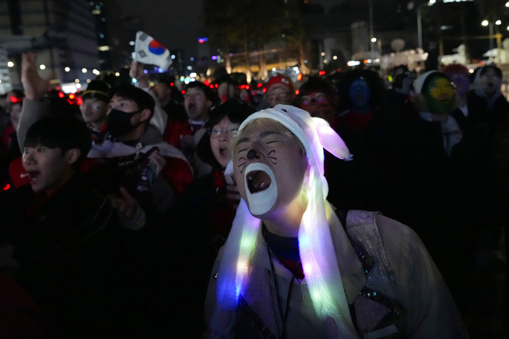 A South Korean soccer fan reacts as he watches a live broadcasting of the World Cup 2022 round of 16 soccer match between South Korea and Brazil in Qatar, at a public viewing venue in Seoul, South Korea, Tuesday, Dec. 6, 2022. (AP Photo/Ahn Young-joon)