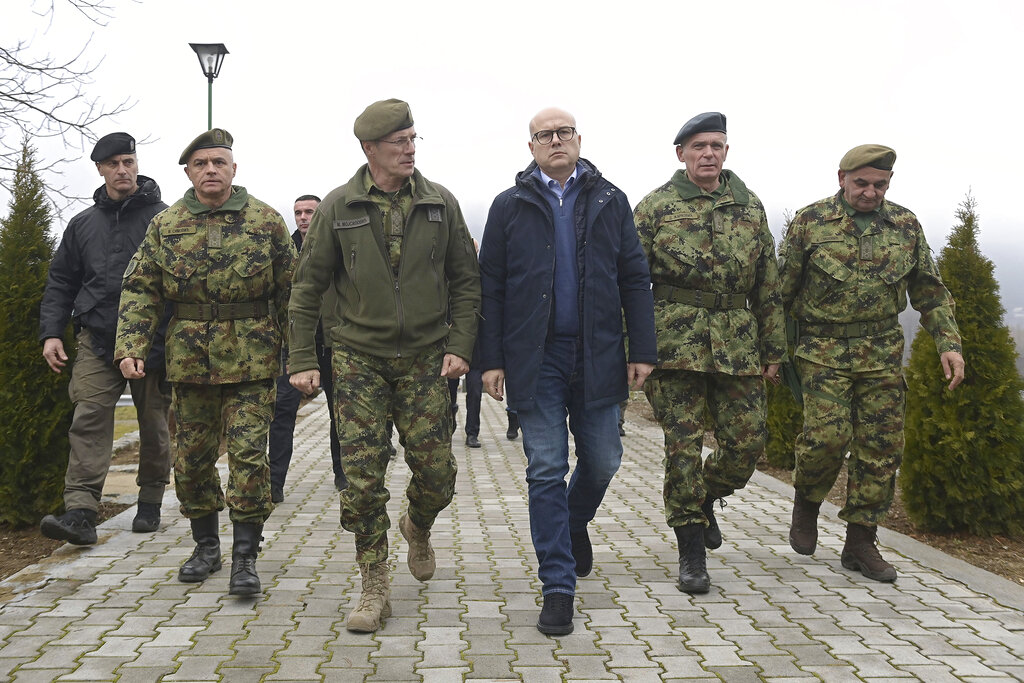 In this photo provided by the Serbian Defence Ministry Press Service, Serbia Defence Minister Milos Vucevic speaks with Serbian army chief of staff Milan Mojsilovic at the army barracks in Raska, south Serbia.