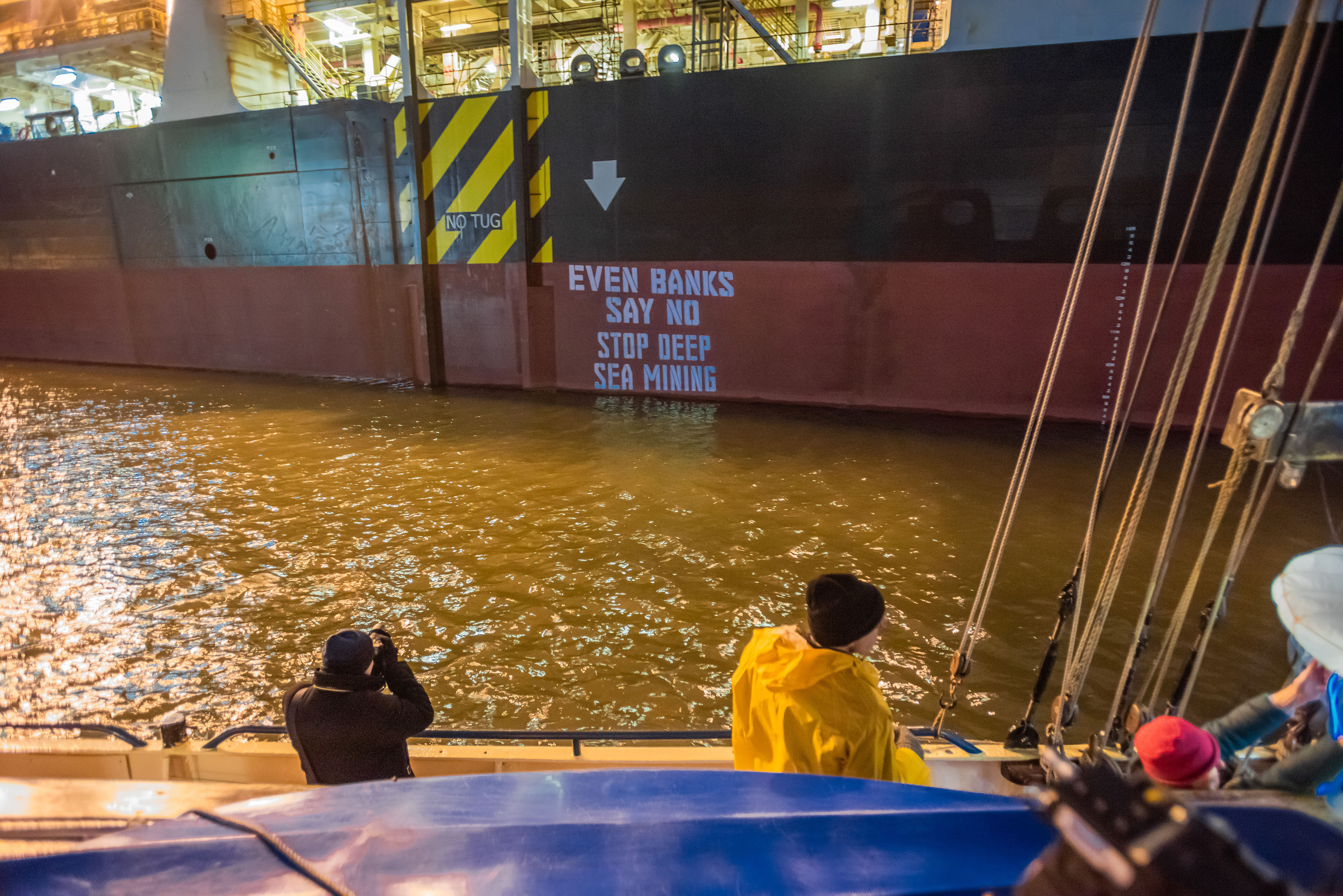 A slide show of texts are projected onto the side of the Hidden Gem during a Ocean Rebellion protest, on February 8, 2022.