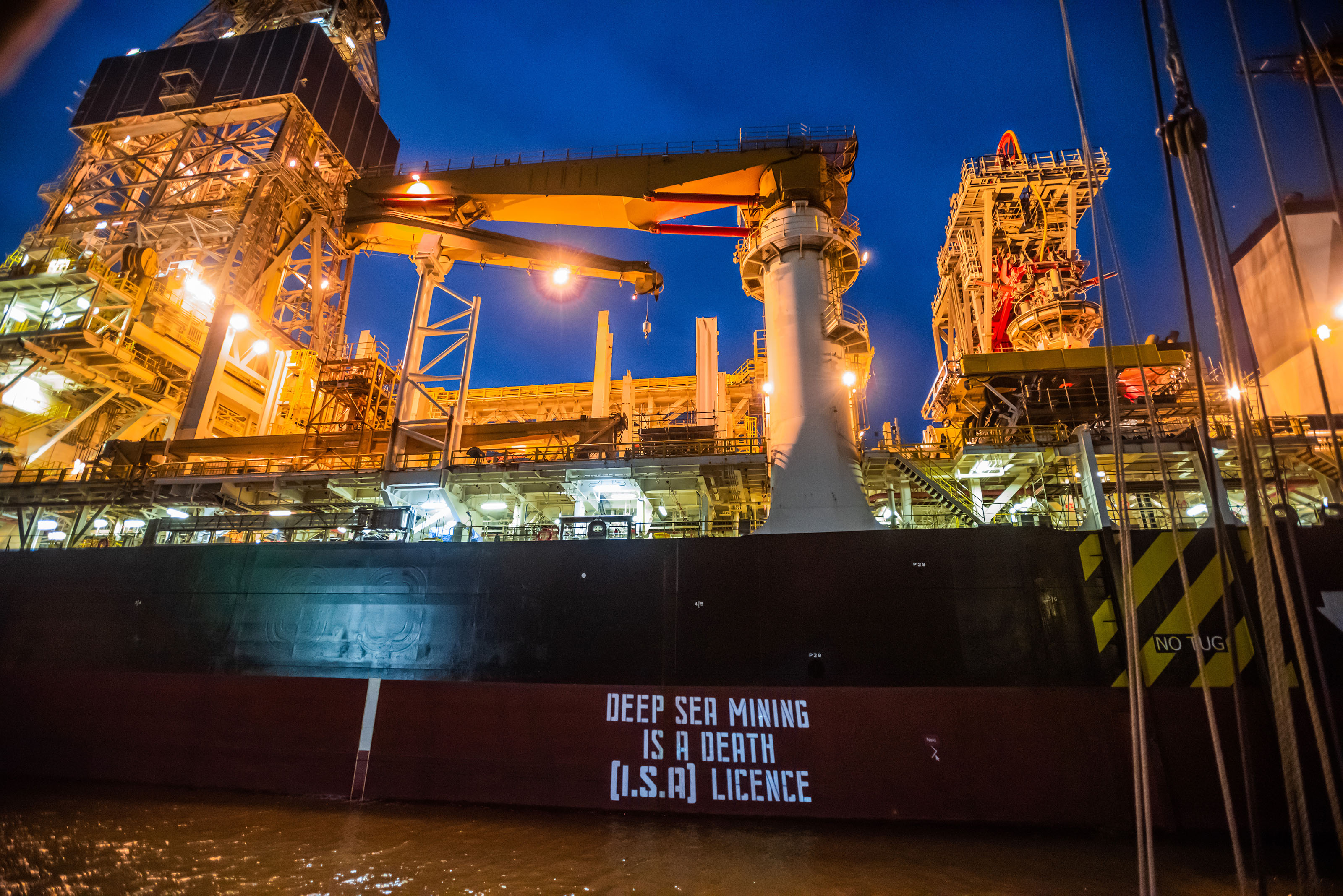 A slide show of texts are projected onto the side of the Hidden Gem during a Ocean Rebellion protest, on February 8, 2022.