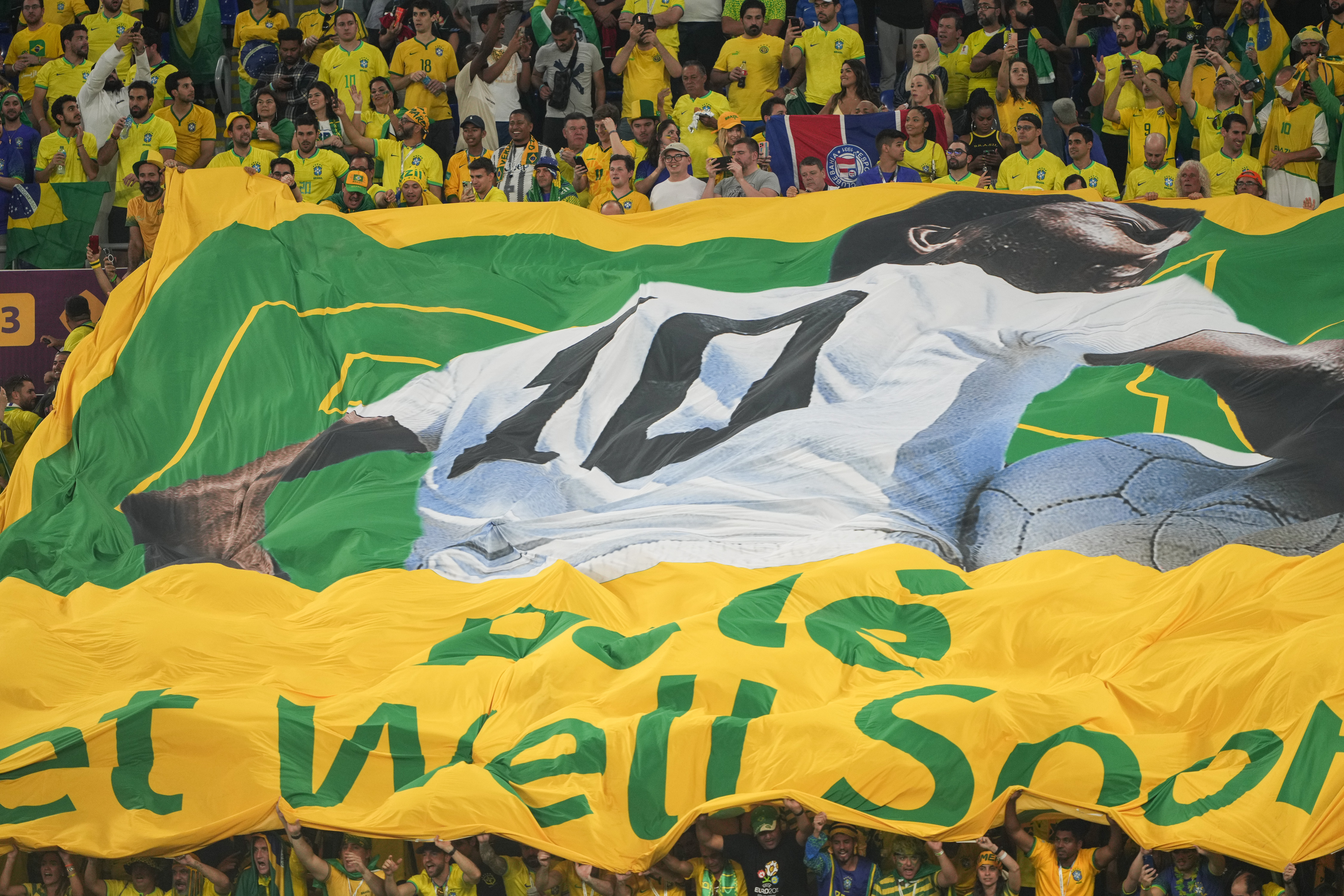 A huge banner with a message for Pele to 'get well soon' is unfurled in the stands at Stadium 974 in Doha, Qatar.