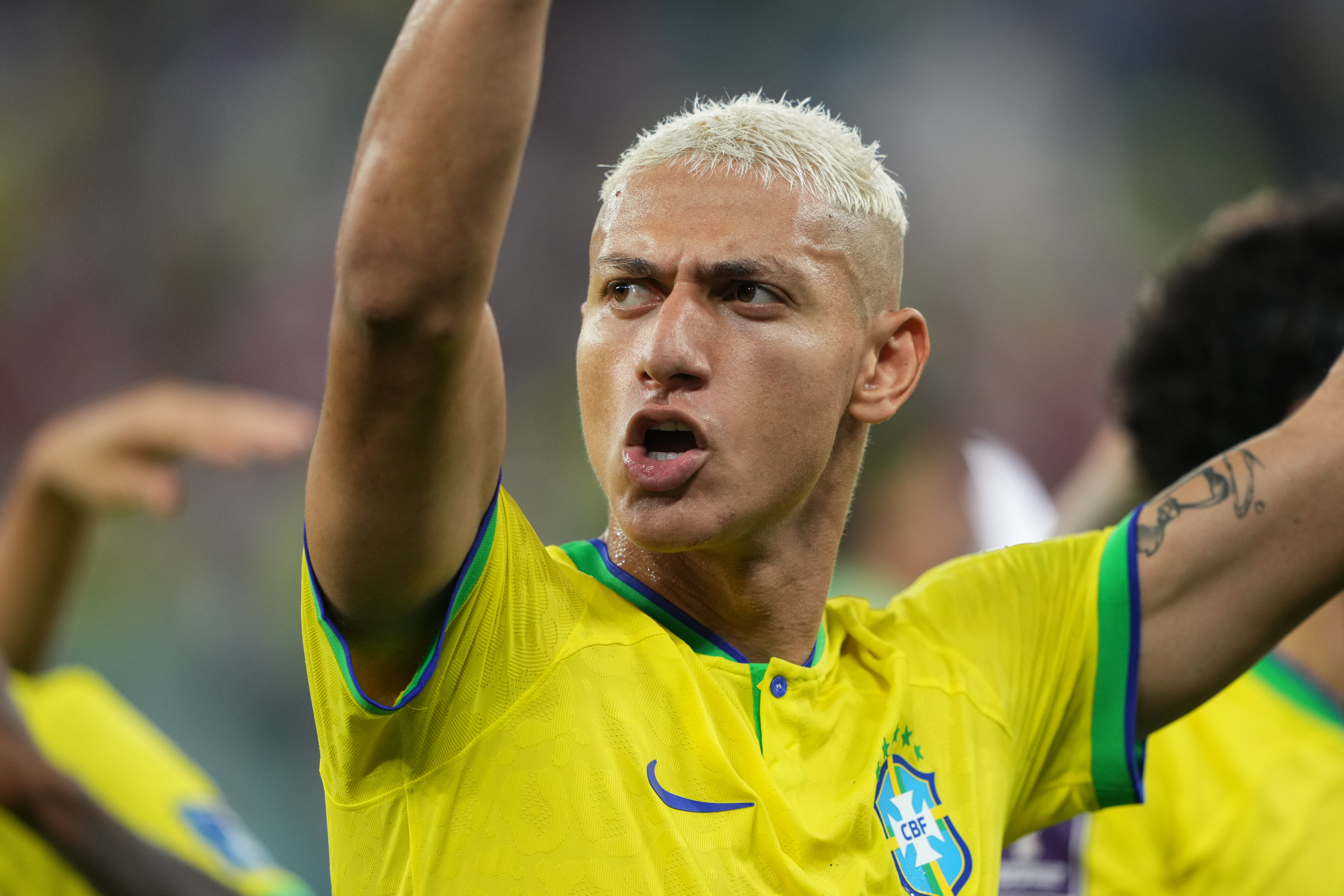 A victorious Richarlison celebrates Brazil's victory.