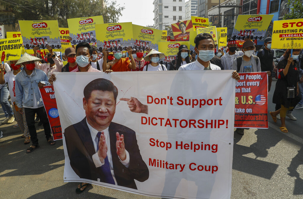 Demonstrators display a picture of Chinese president Xi Jinping, with a message requesting not to support military coup during a protest against the military coup in Mandalay, Myanmar