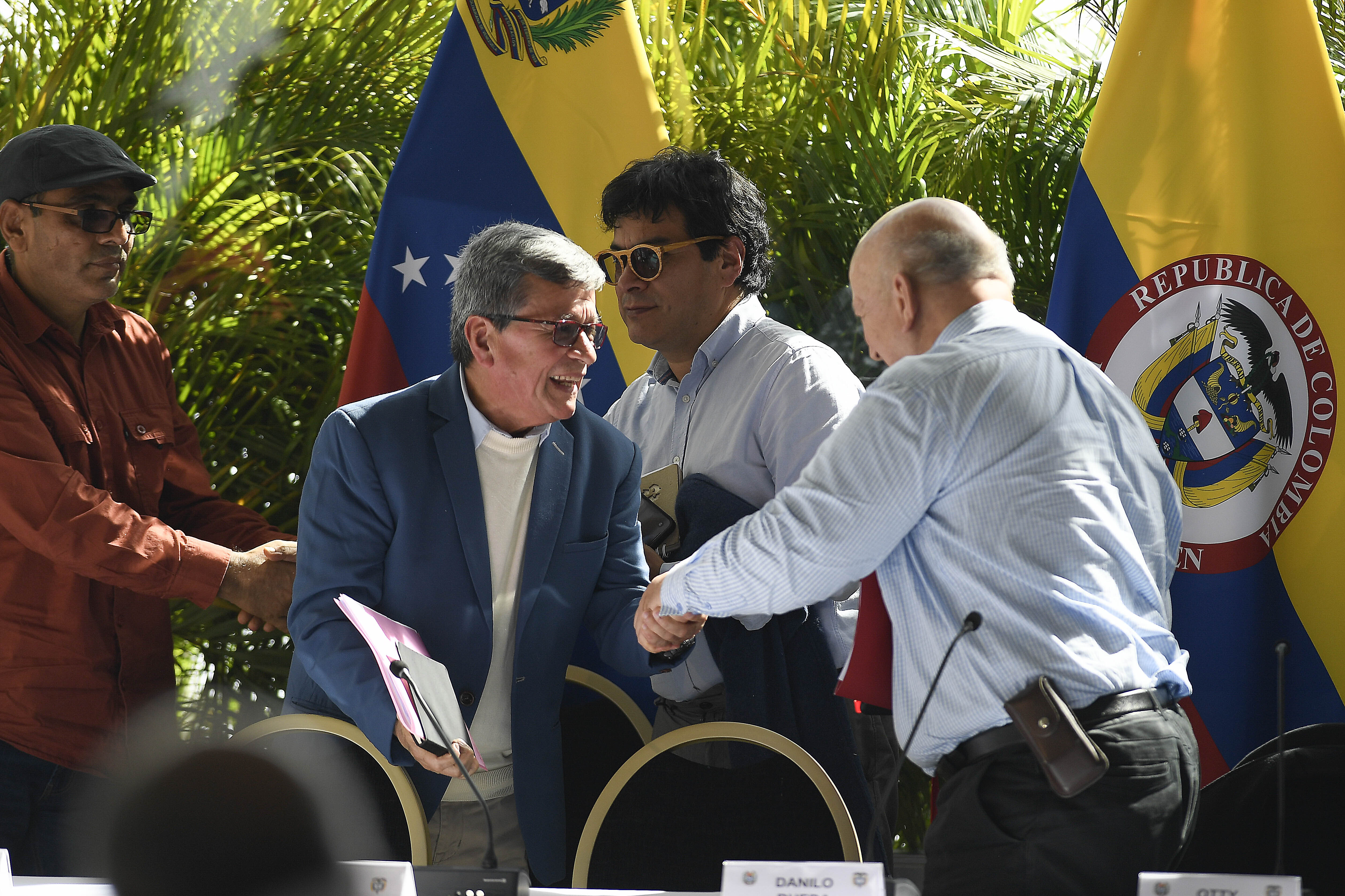 ELN's Pablo Beltran shakes hands with Otty Patino of the Colombian government
