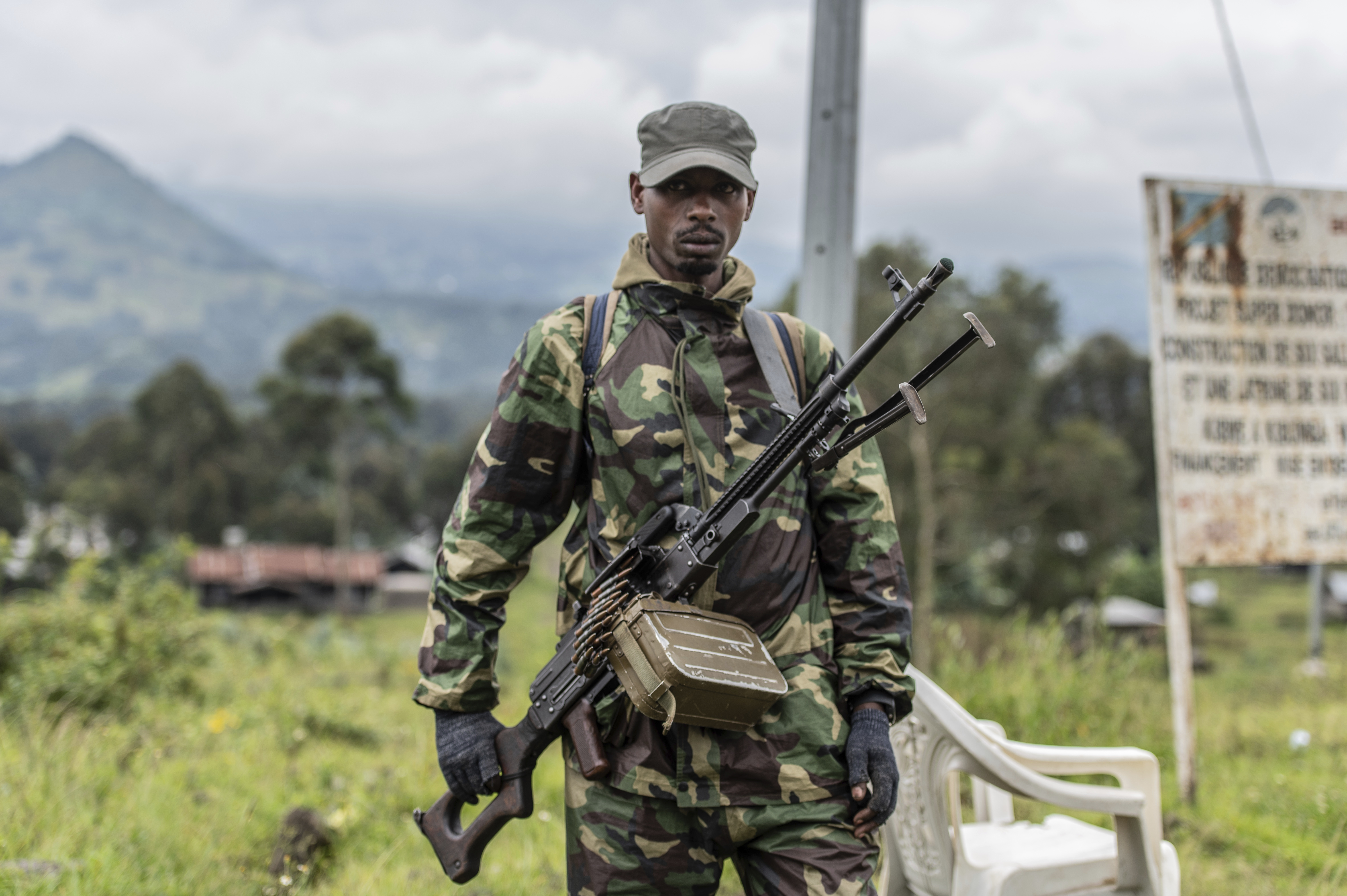 An M23 rebel stands with his weapon during a ceremony to mark the withdrawal from their positions in the town of Kibumba, in the eastern Democratic Republic of the Congo, on Friday, December 23, 2022