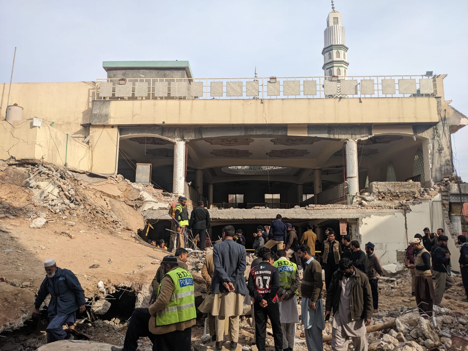 Rescuers search through the rubble of a mosque in Peshawar after it was hit by a suicide bombing