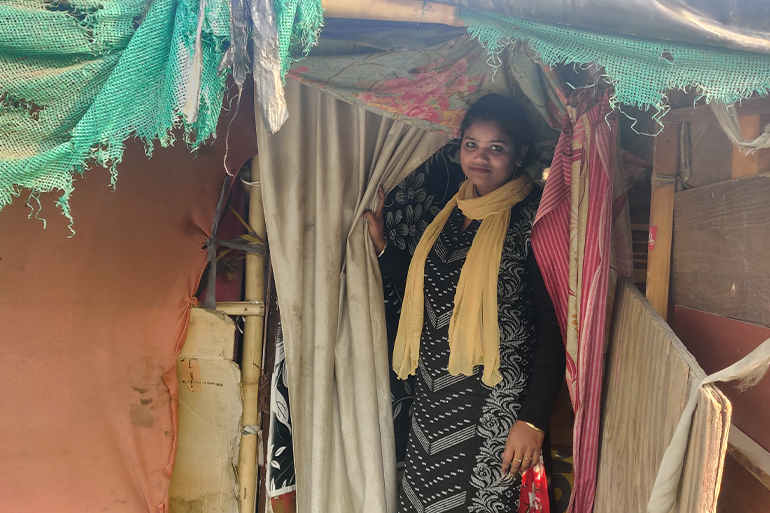 Gunja standing in the doorway of her old home.