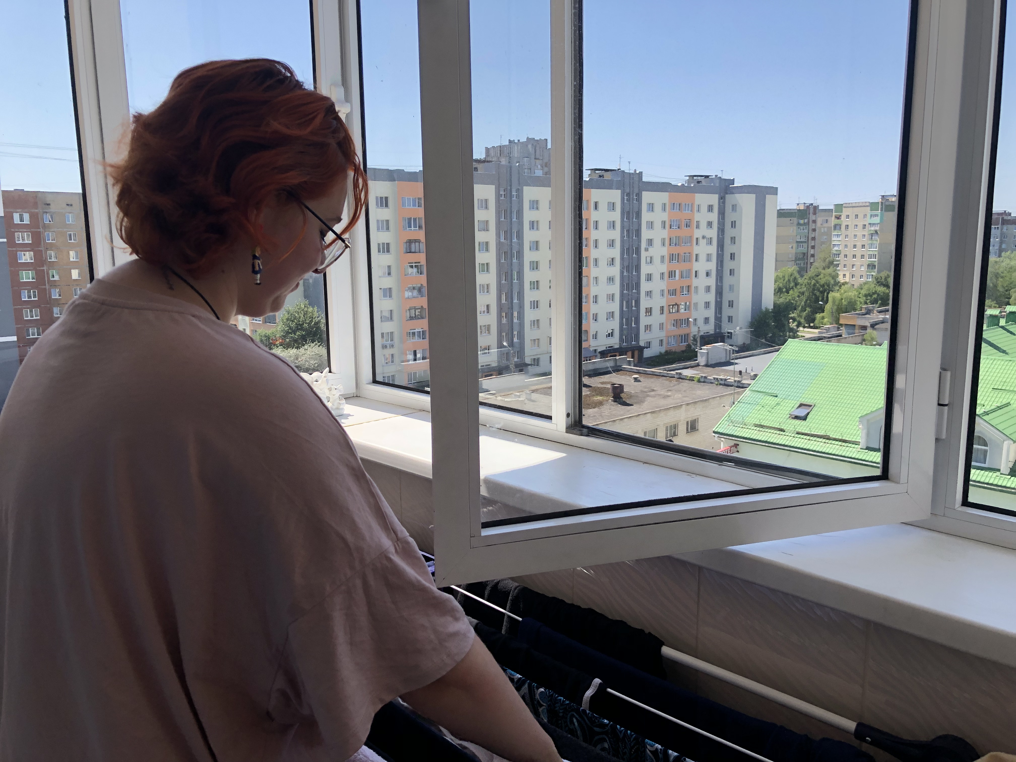A photo of Tanya standing in front of an open window.