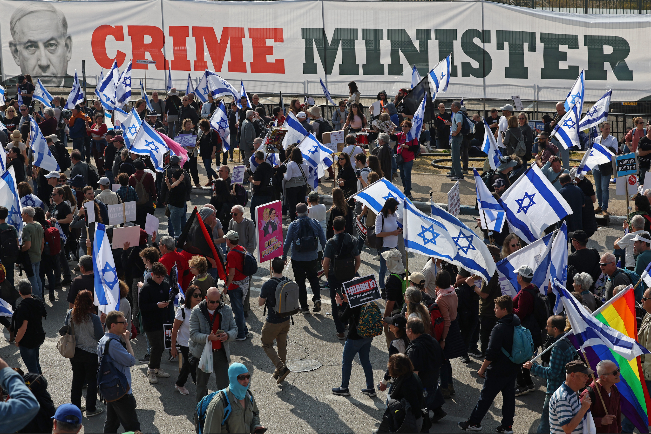 People gather with Israeli flags during a protest against the government's judicial reform bill near the Knesset (parliament) in Jerusalem on February 20, 2023.