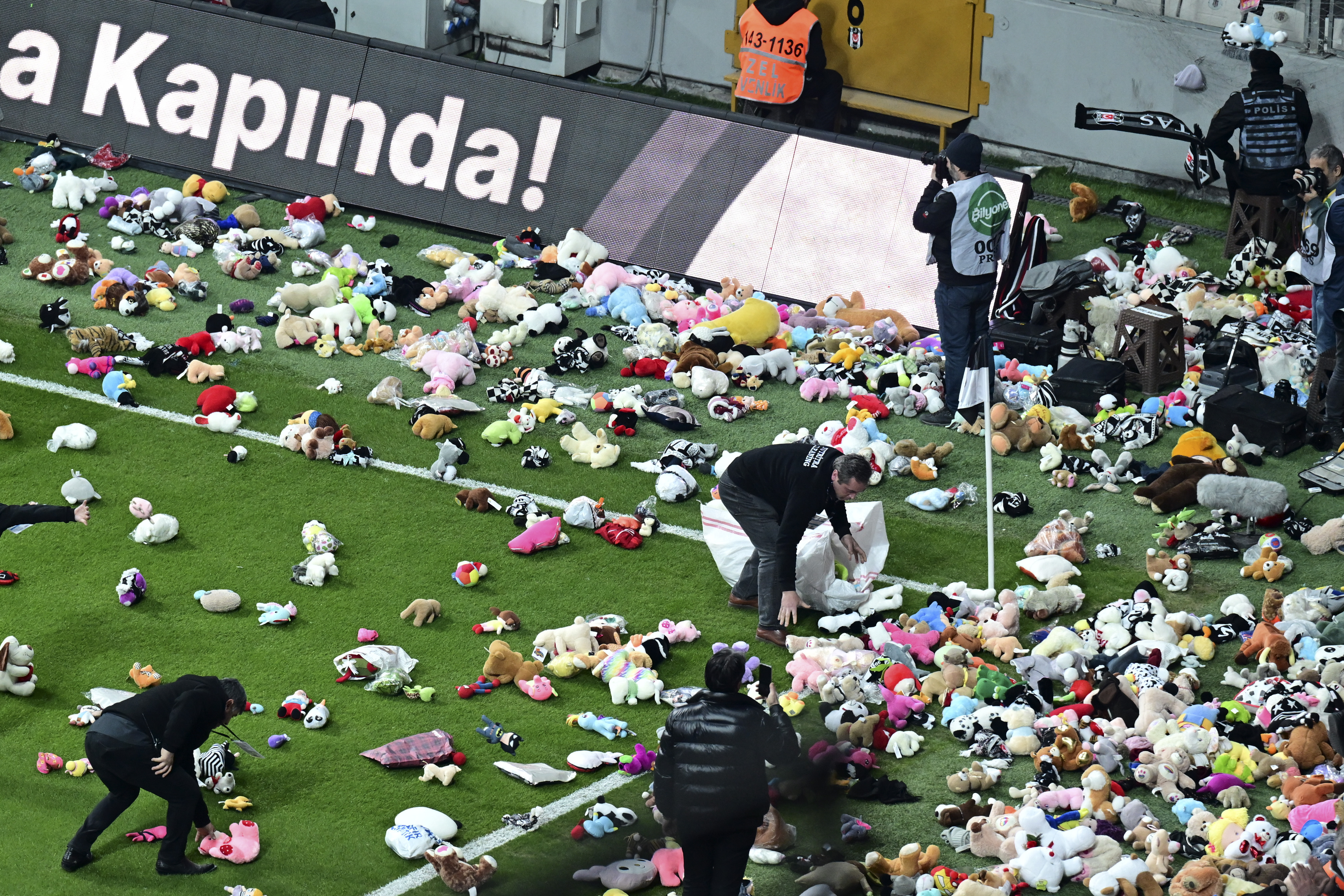 Fans throw toys onto the pitch during the Turkish Super League football match
