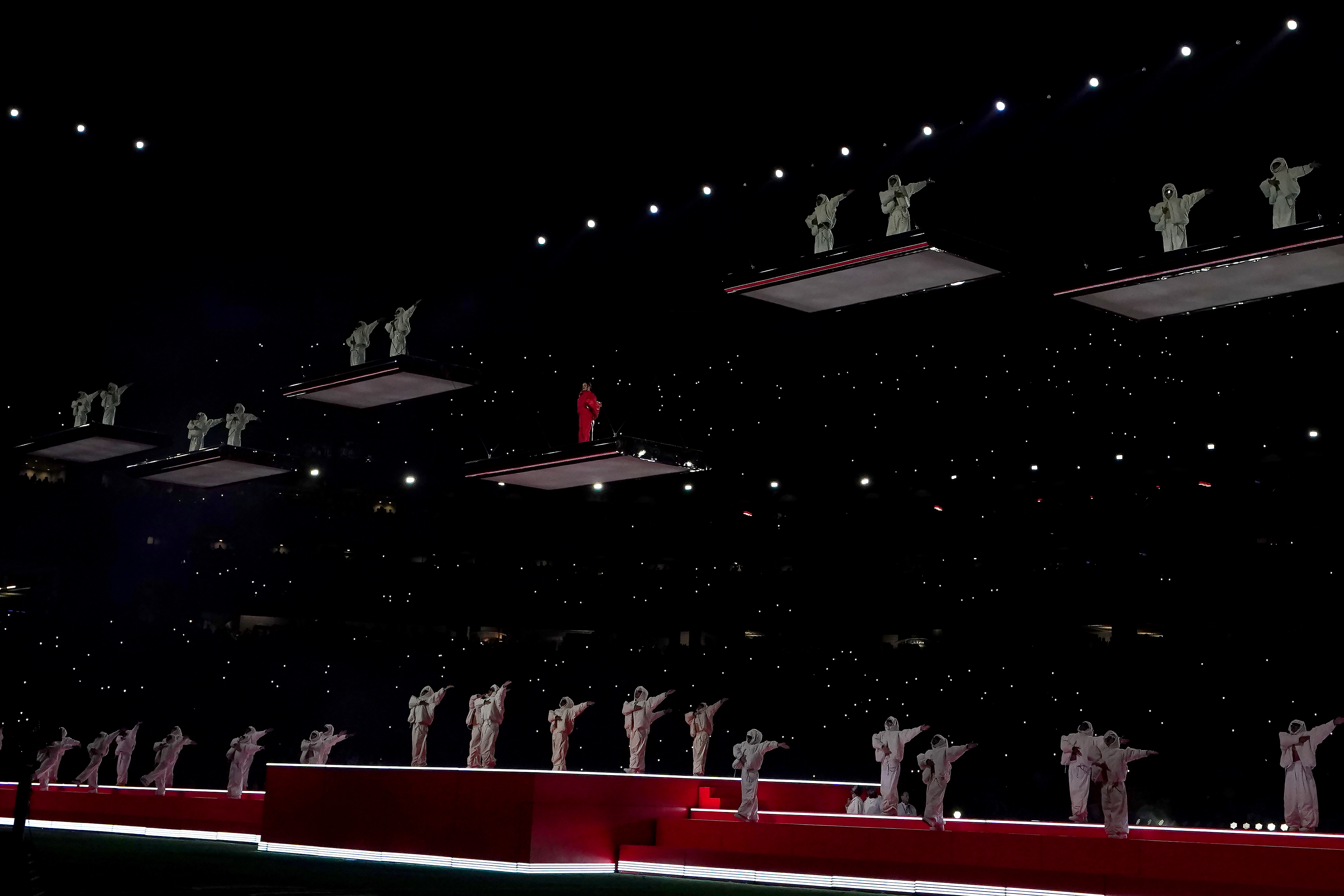 Rihanna and her dancers suspended above the stage on separate platforms.