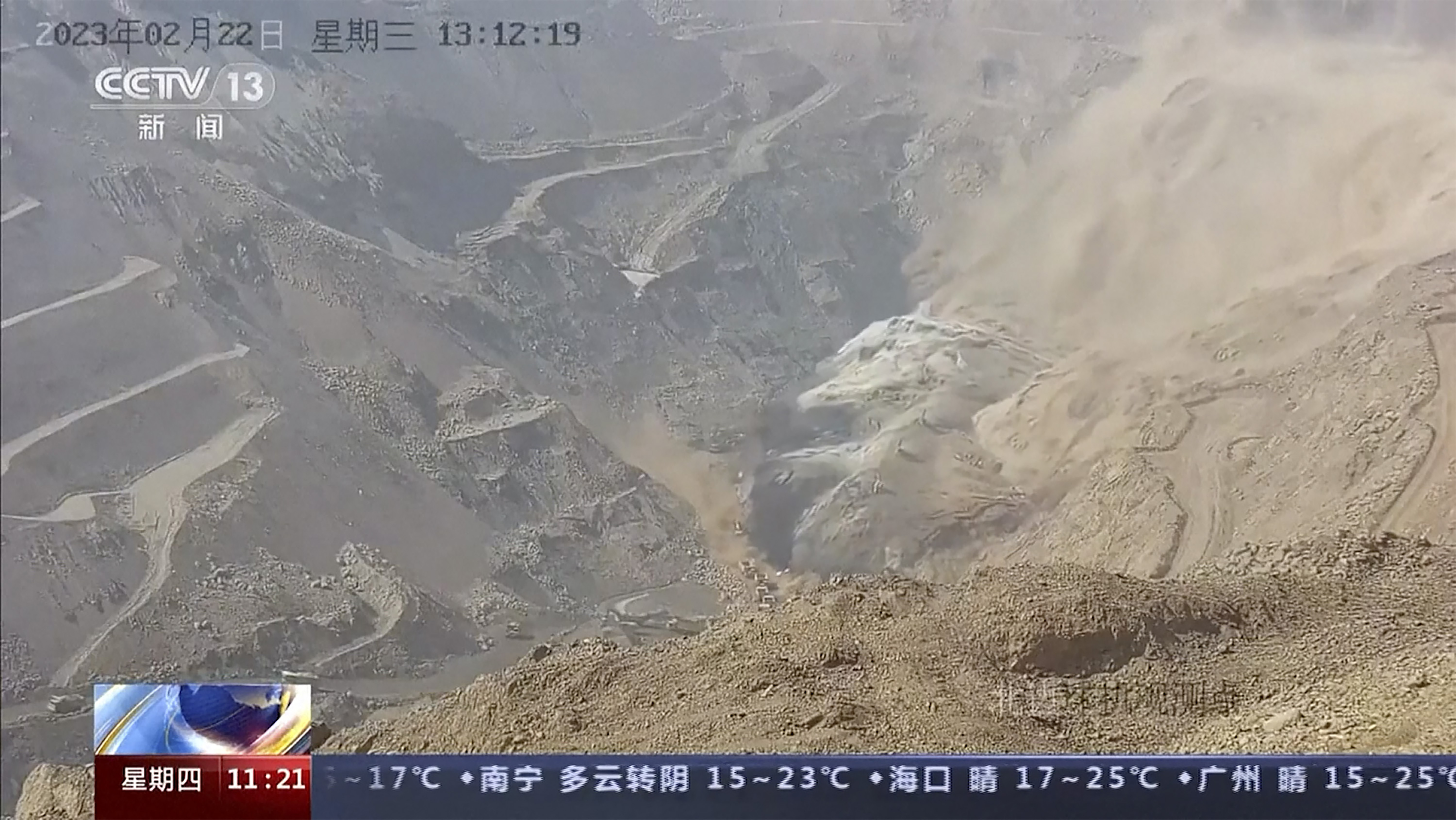 In this image taken from official surveillance camera footage run by China's CCTV, dirt moves down the side of a hill at an open pit mine in Alxa League