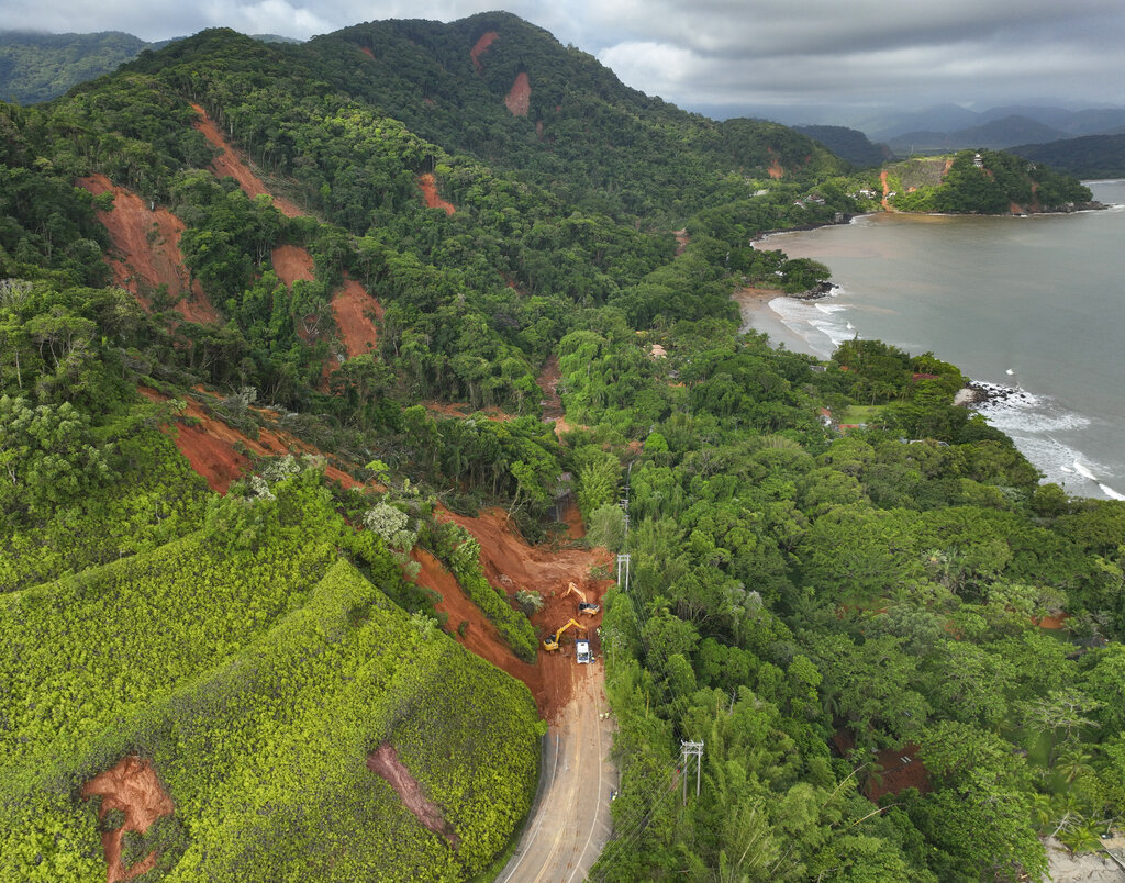A road is blocked by a mudslide triggered by heavy rains