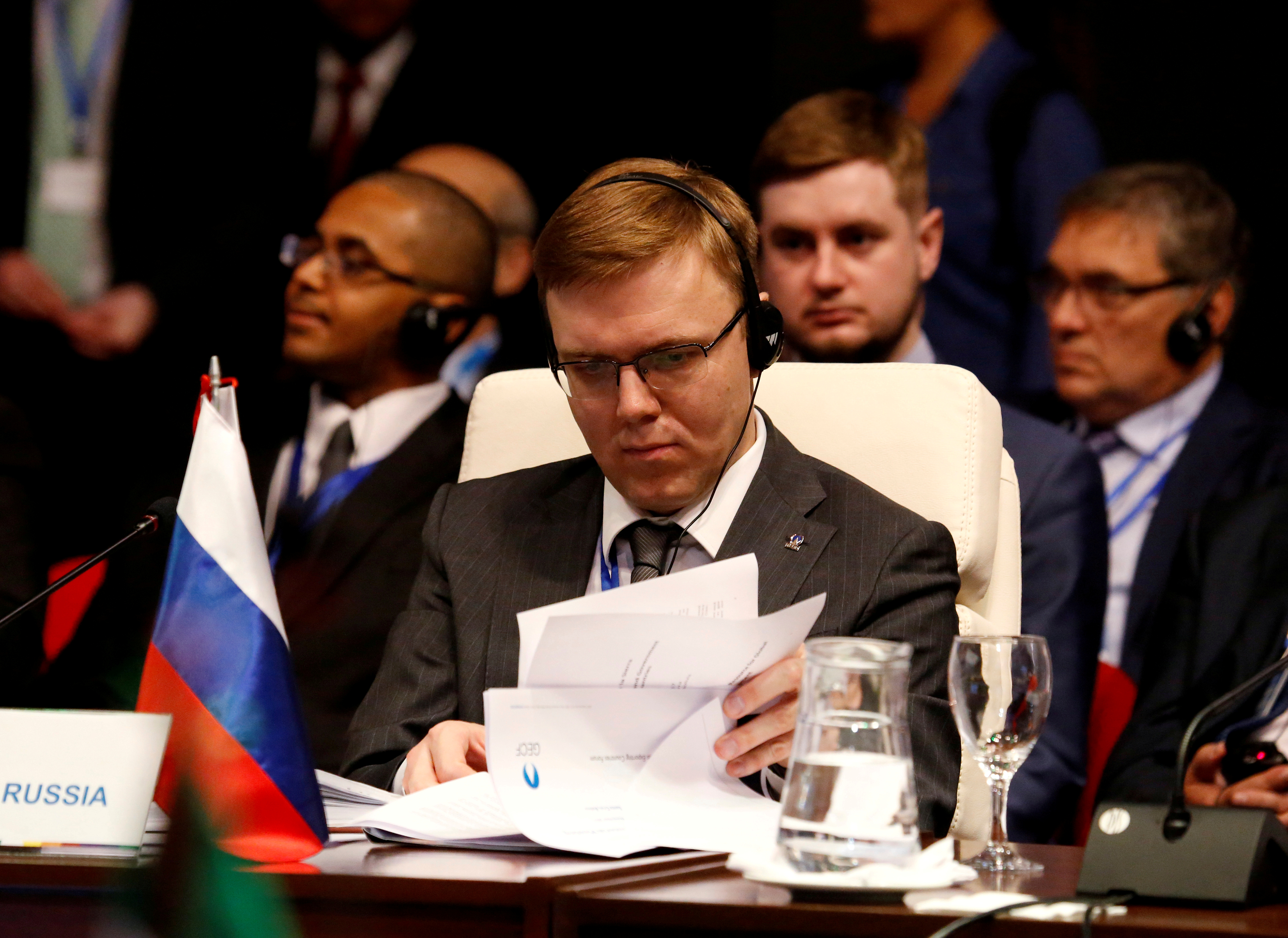 Roman Marshavin, an Executive Director at the Board of the World Bank Group, riffling through papers in front of him while attending a summit in Bolivia.