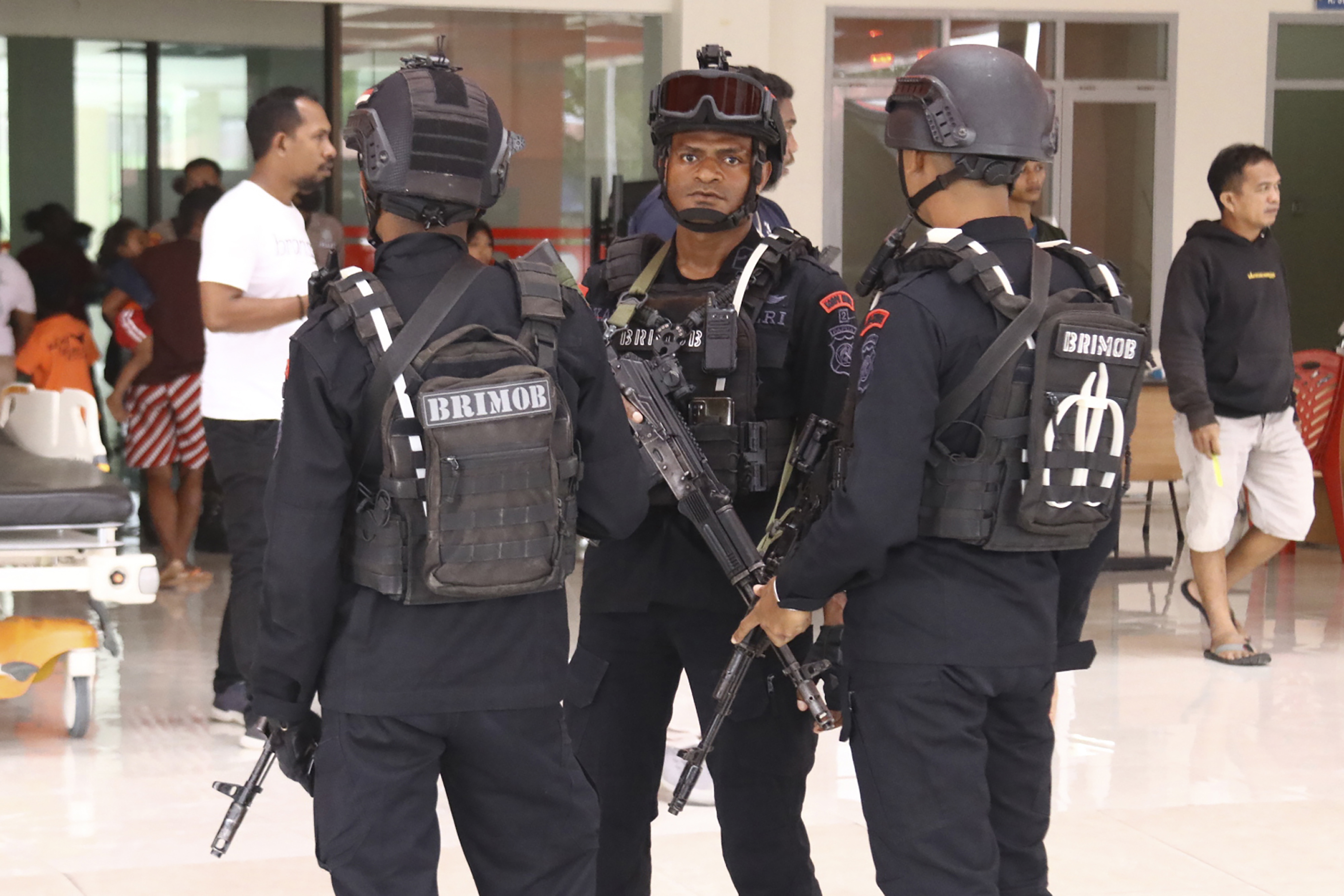 Heavily-armed police guard a hospital where workers threatened by Papuan rebels were brought for medical examinations in Mimika, Papua province, Indonesia.