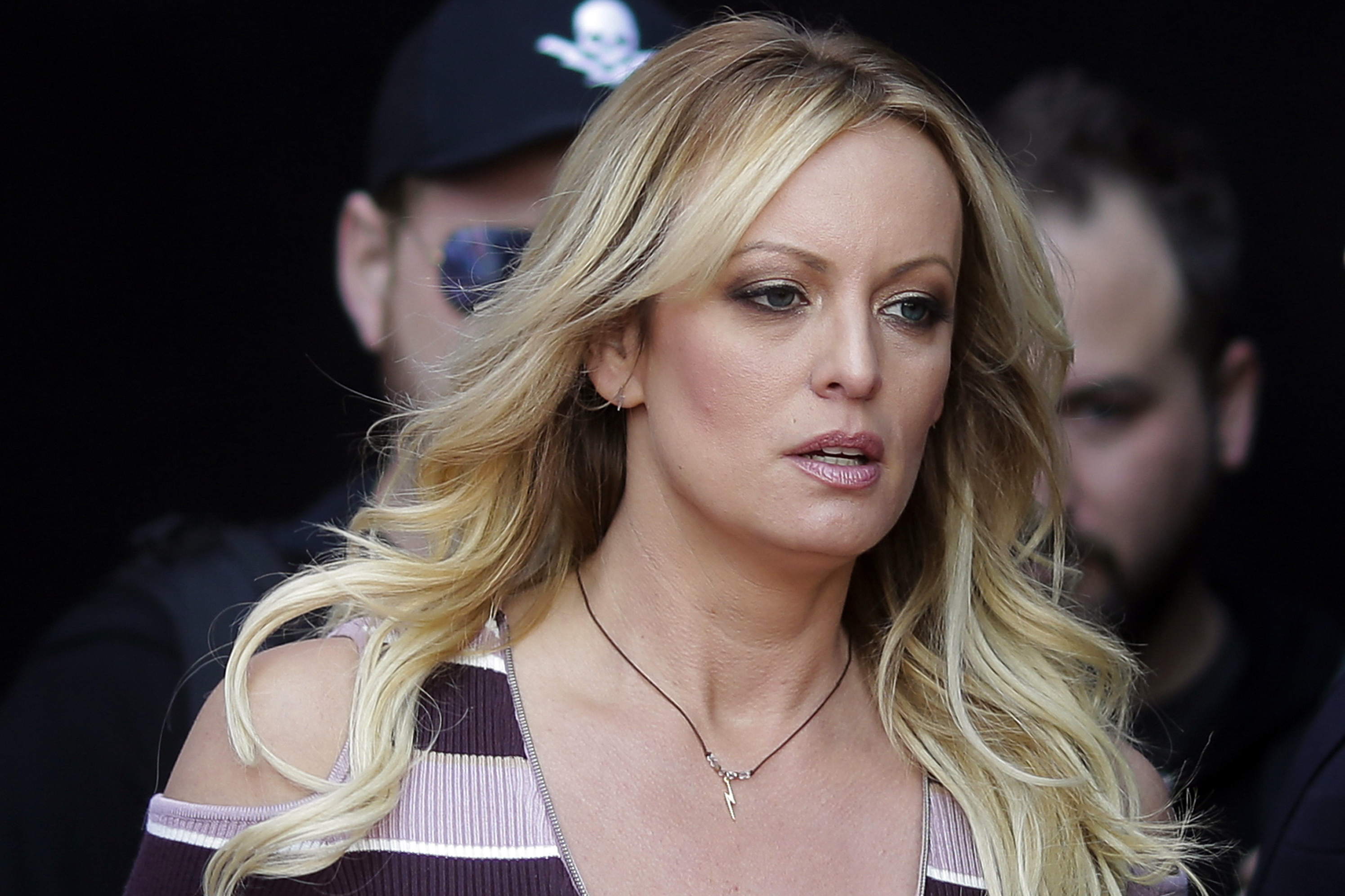 Stormy Daniels seen walking, with law enforcement behind her