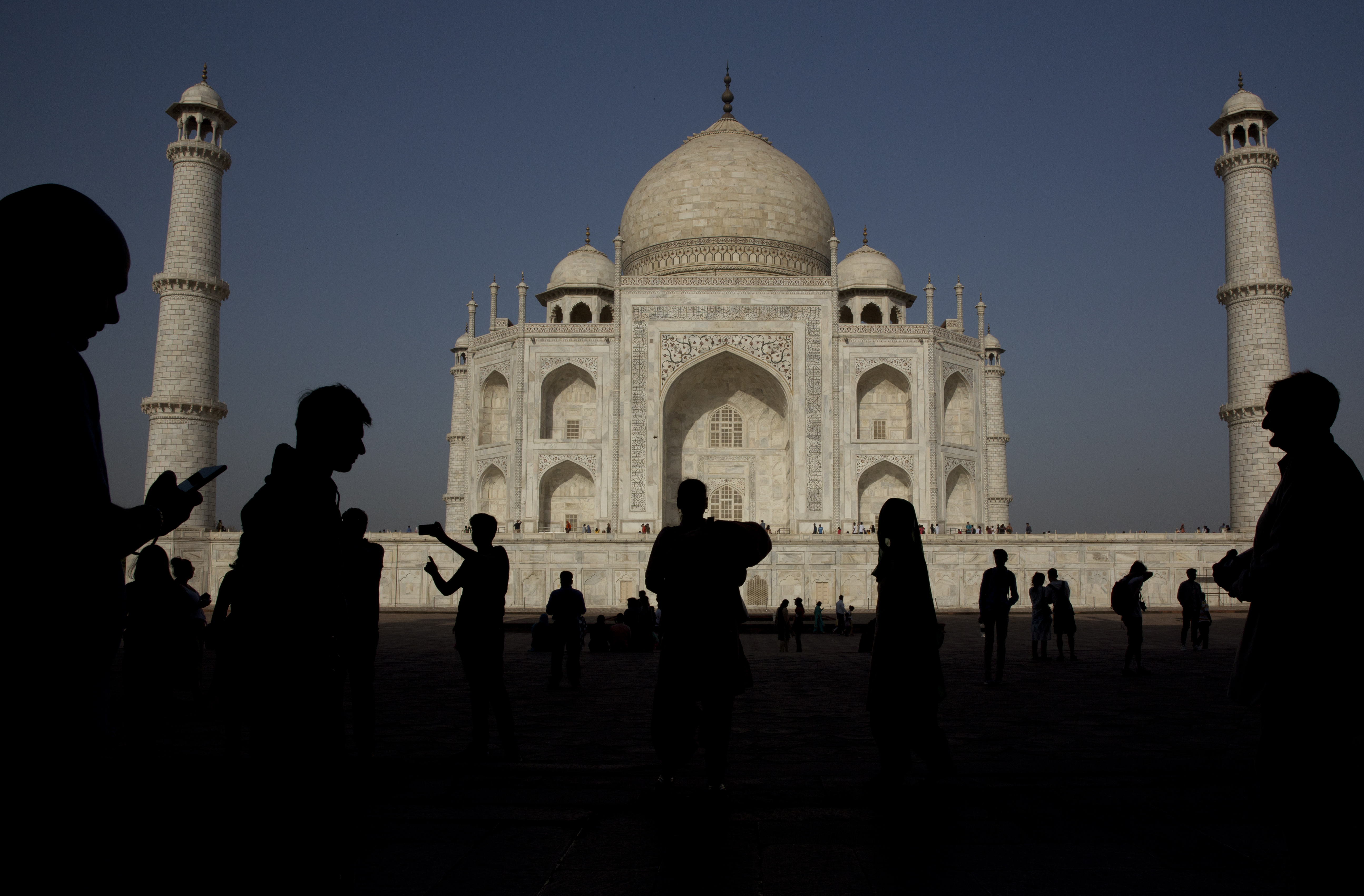 Indian and foreign tourist watch and take selfies of Taj Mahal, in Agra, India, Sunday, March 24, 2019. Clear skies and warm weather bring out crowds of people to visit the marble mausoleum on the bank of the Yamuna river. (AP Photo/Manish Swarup)