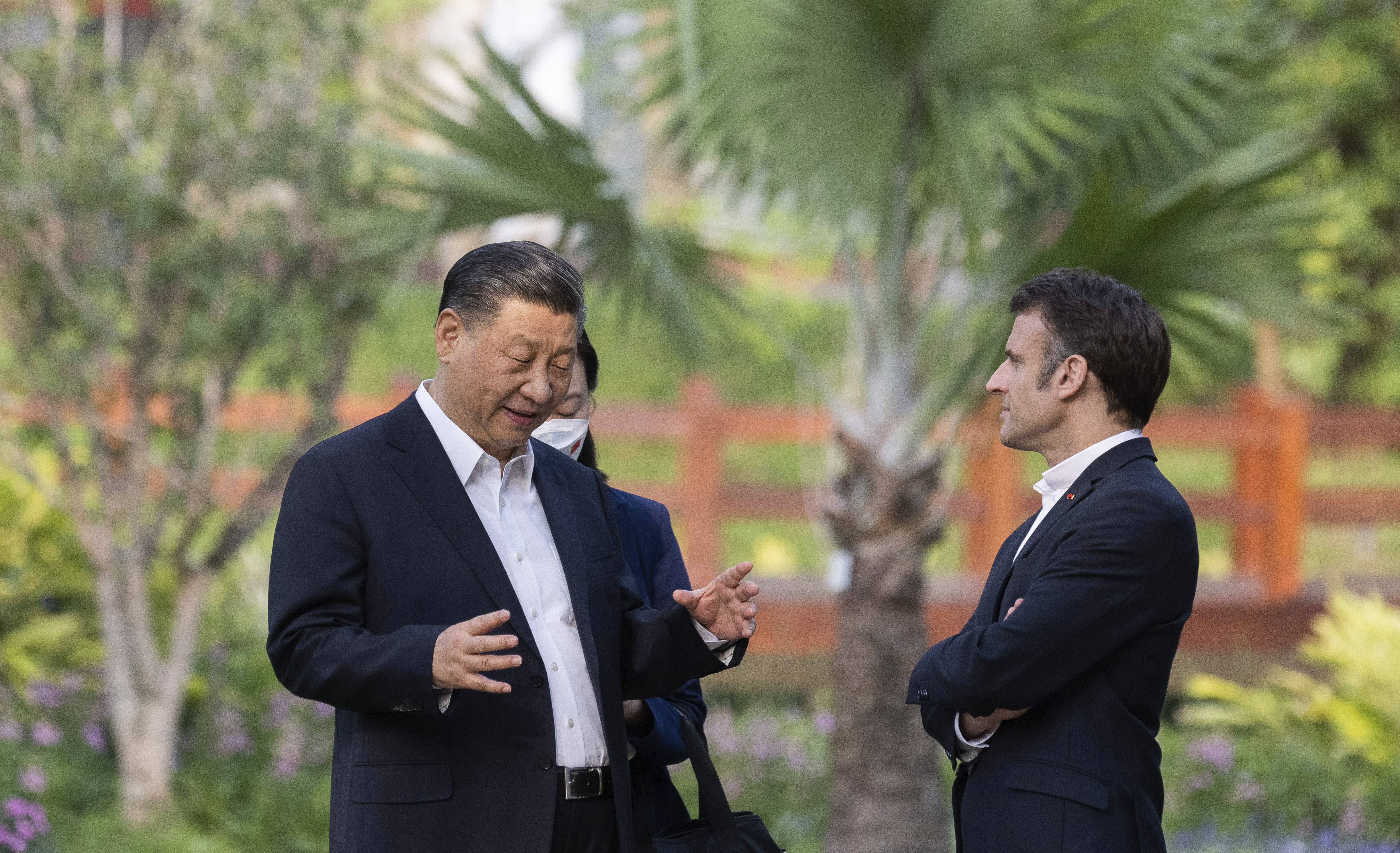 Chinese President Xi Jinping and French President Emmanuel Macron talk in the garden of the Guandong province governor's residence, in Guangzhou, China, April 7, 2023