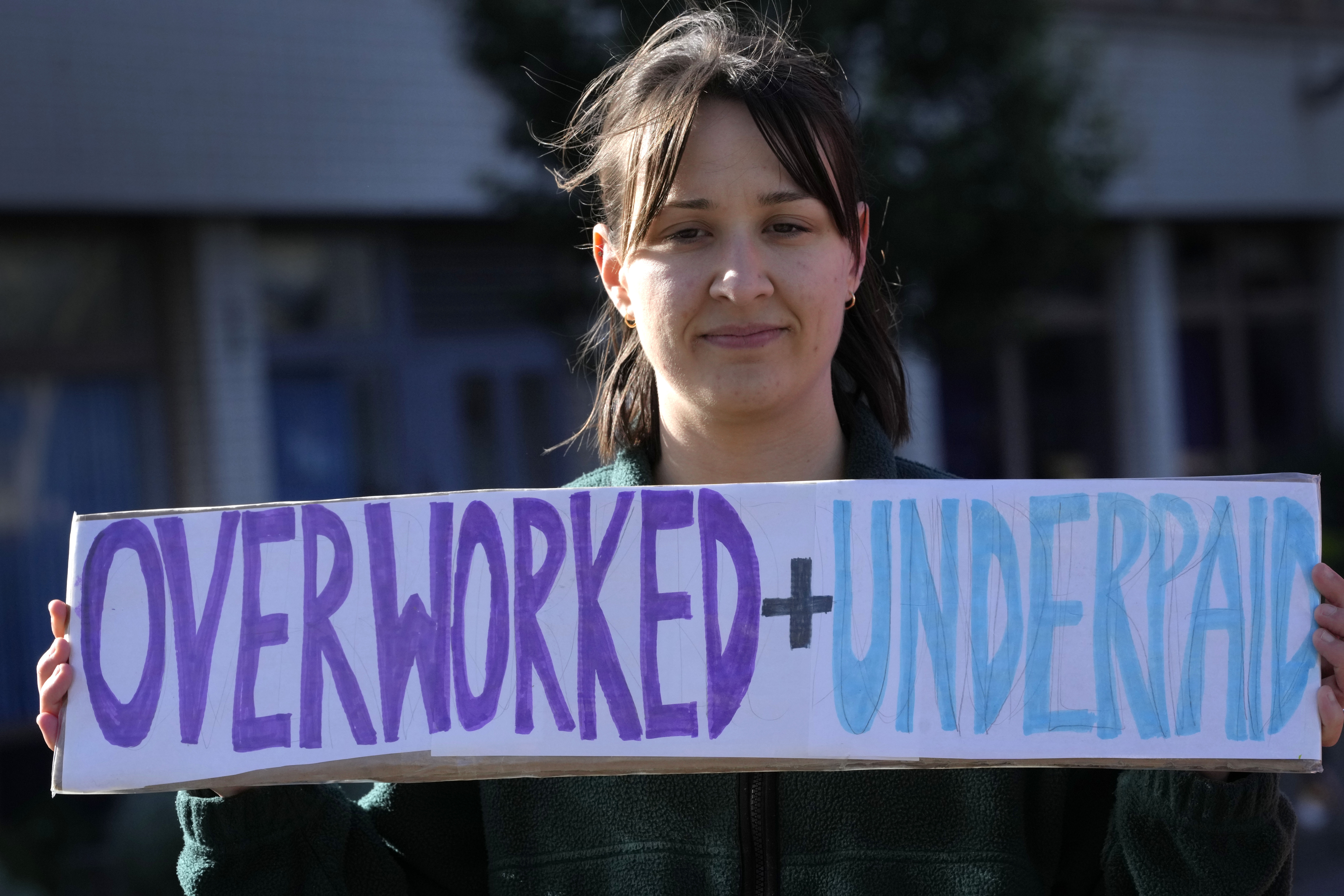 A Junior doctor stands on the picket line outside St Thomas' Hospital in Westminster in London.