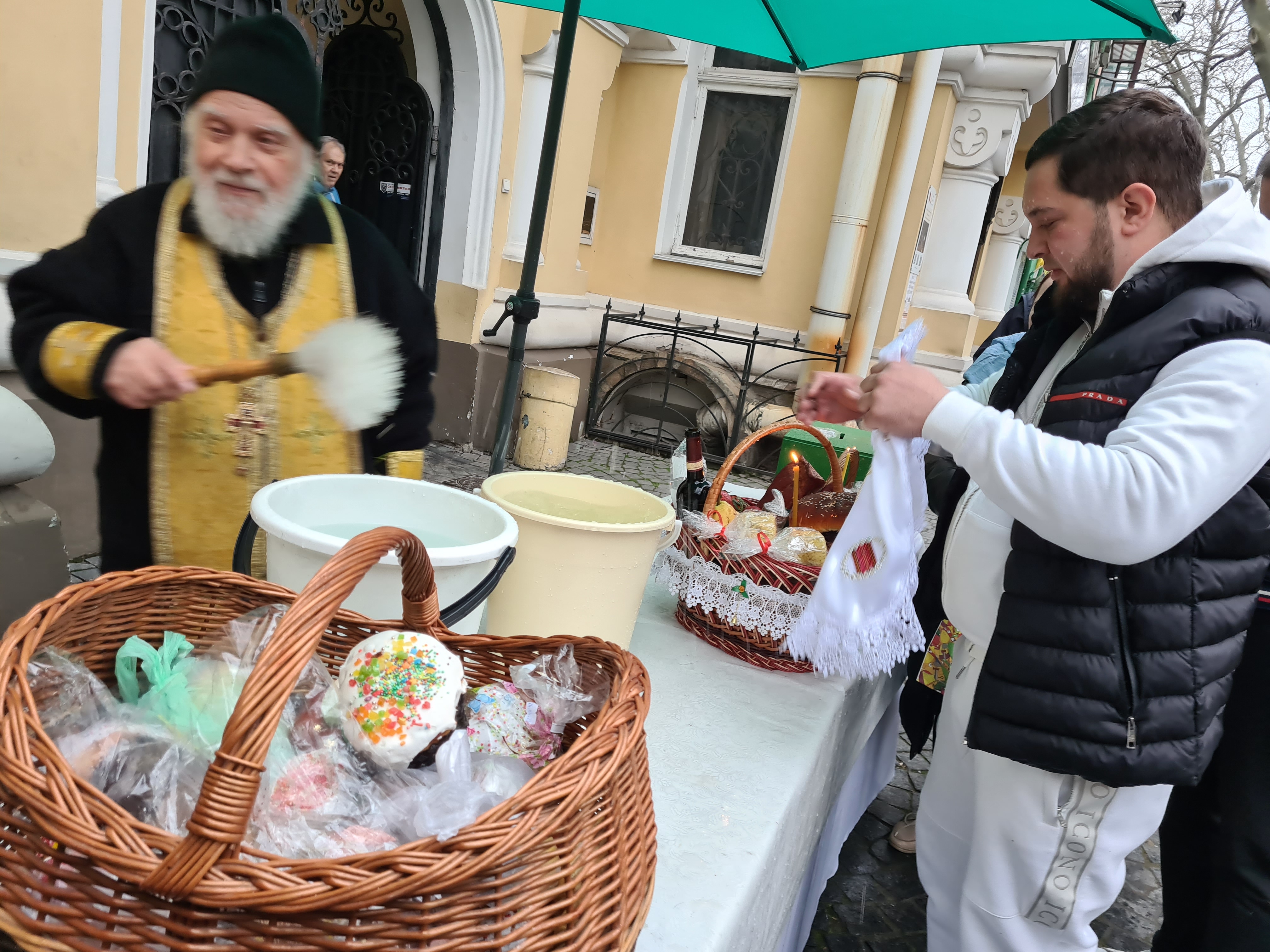 Father Feognost blesses easter eggs and cake in Odesa [File Photo: Mansur Mirovalev]
