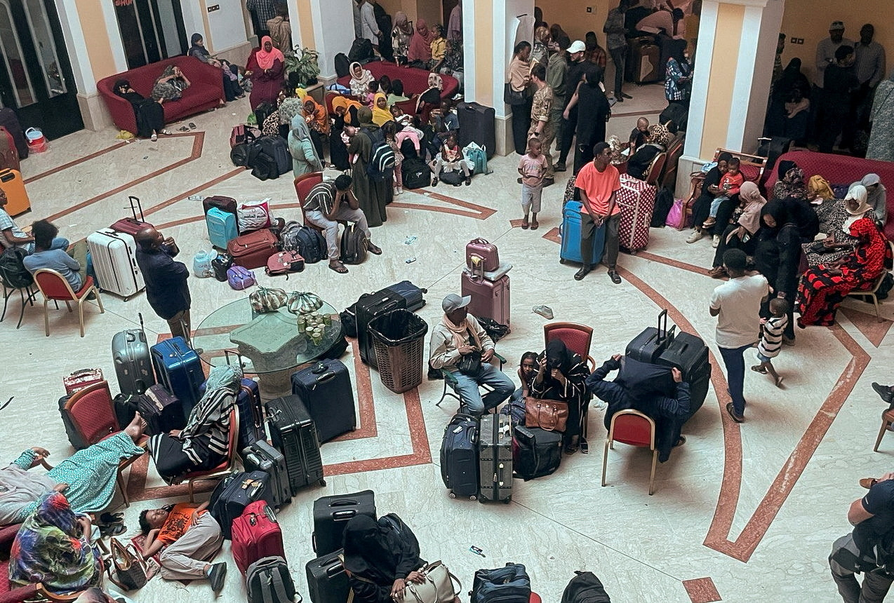 Sudanese citizens wait with their luggage at a makeshift center to be processed for evacuation, following the crisis in Sudan's capital Khartoum, in Port Sudan