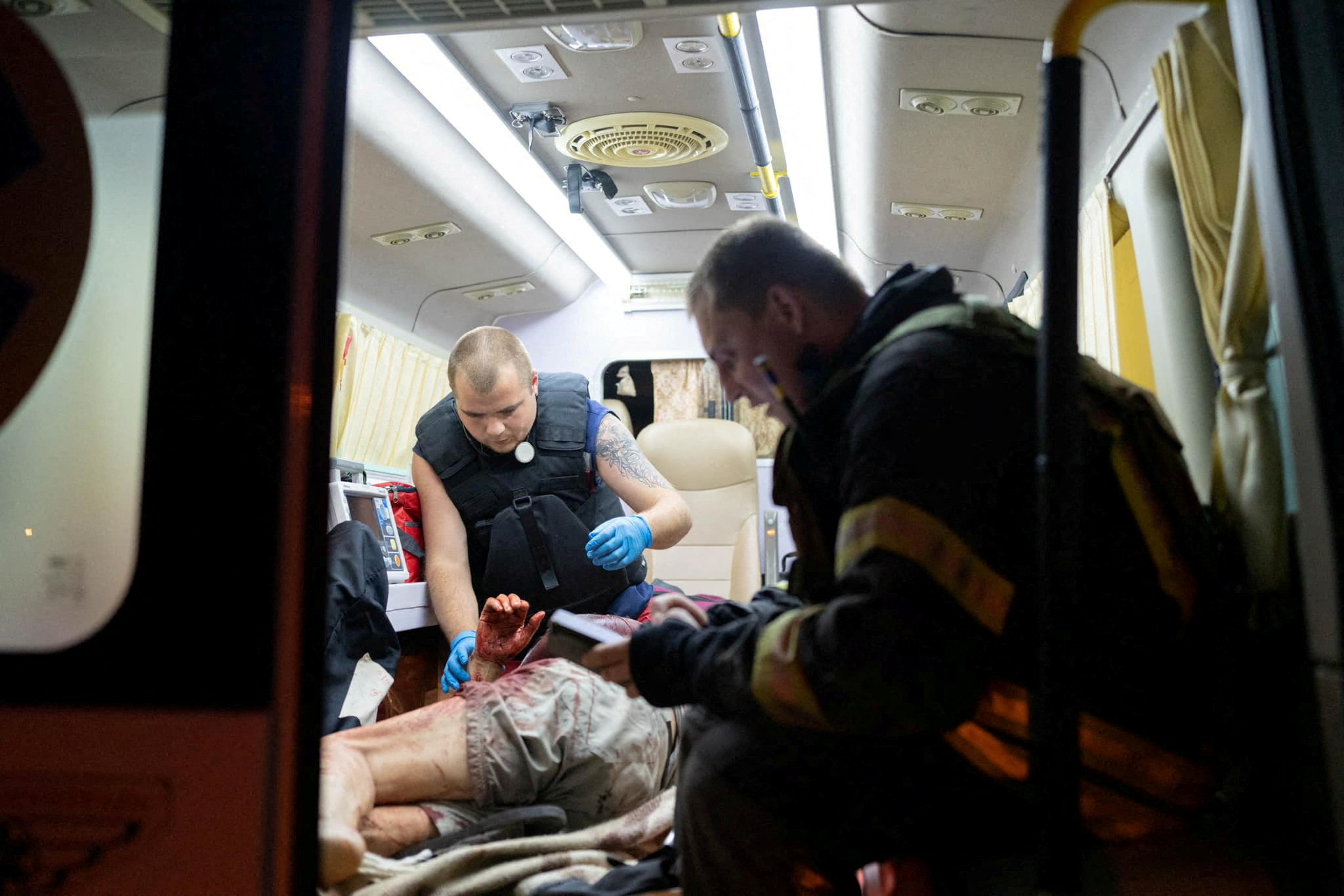 paramedic inspects a person rescued from an apartment building