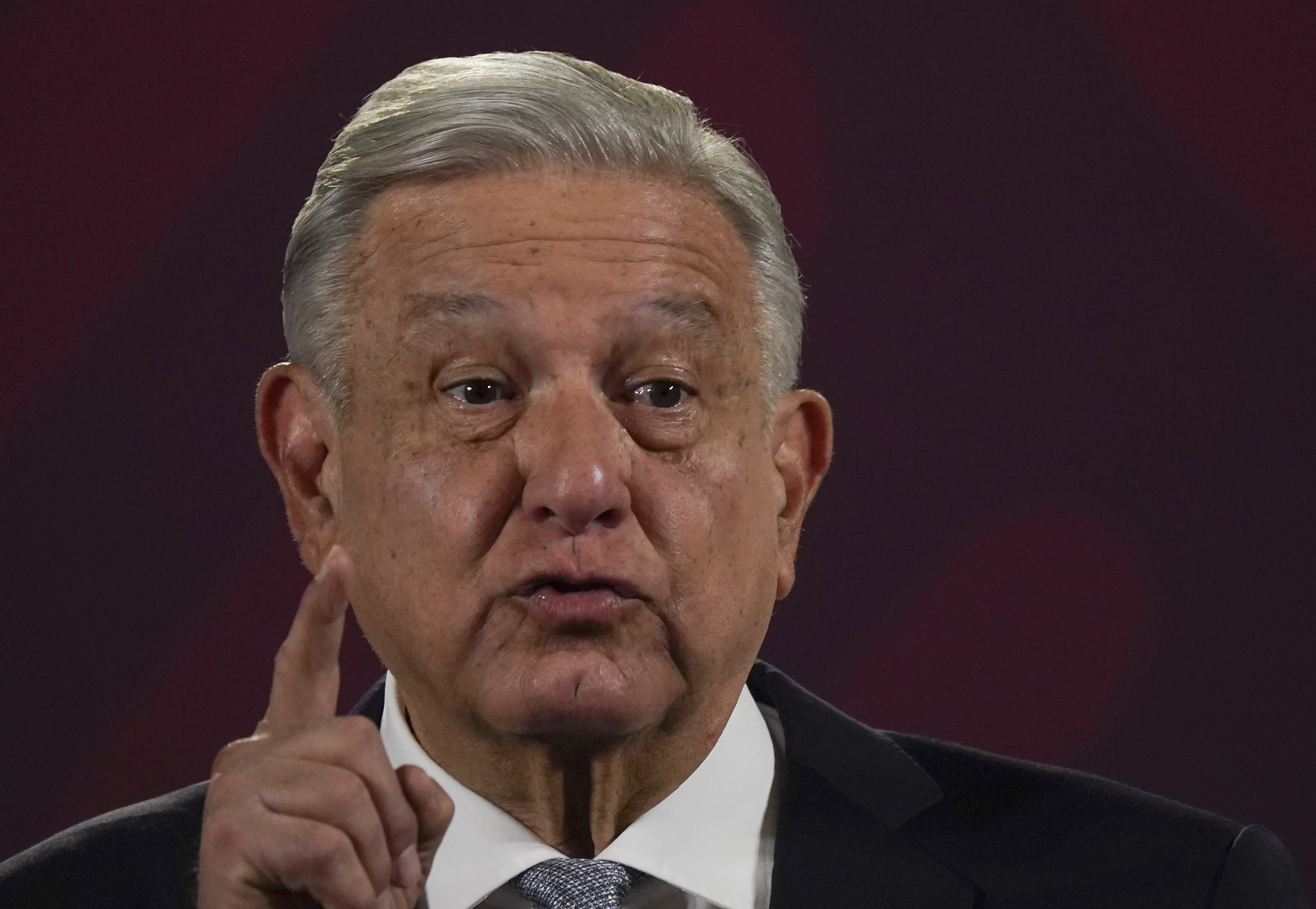 Mexican President Andrés Manuel López Obrador in a close-up shot with one finger pointing up in the air.