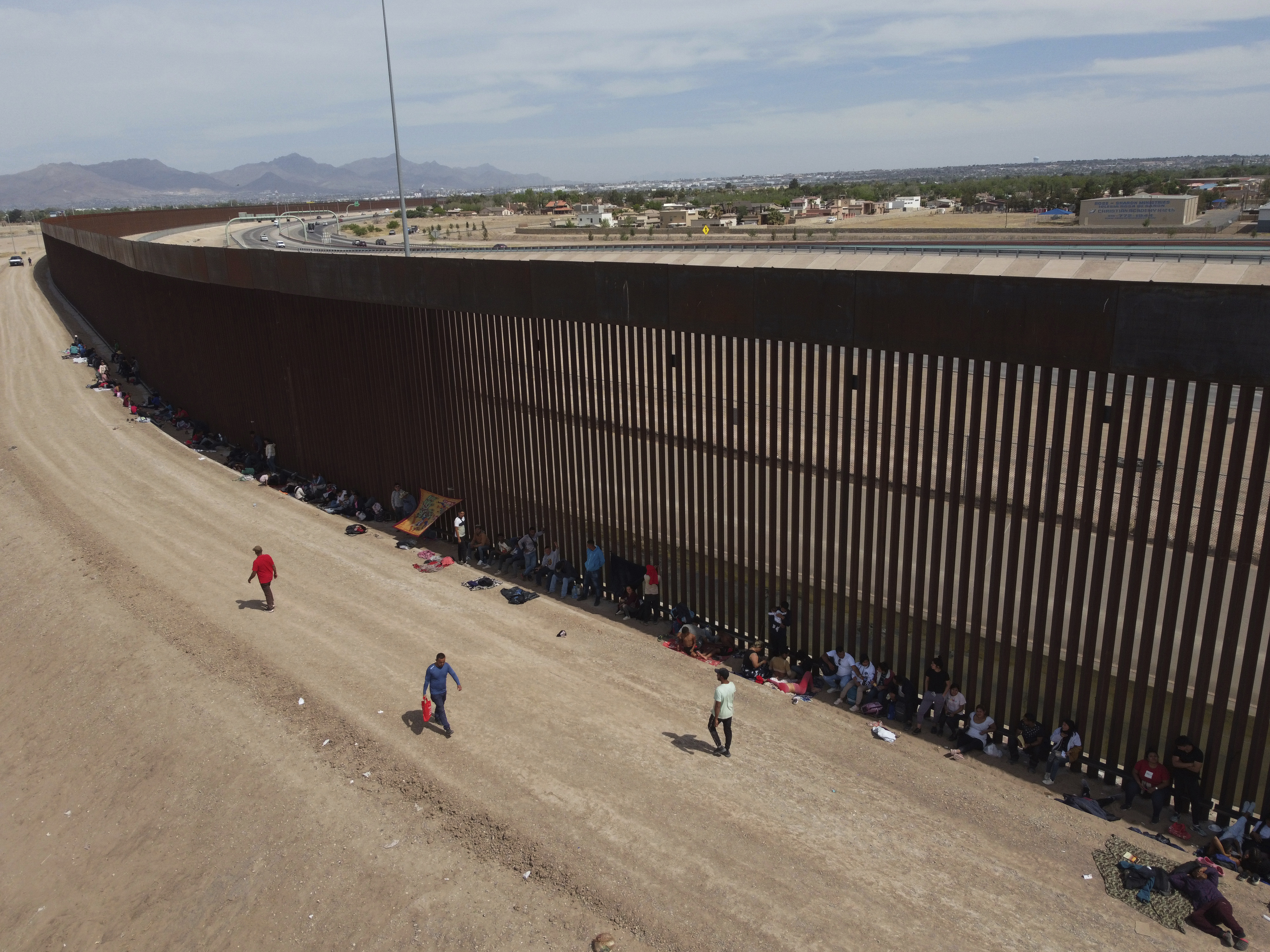 Asylum seekers camp out next to the border wall between the US and Mexico