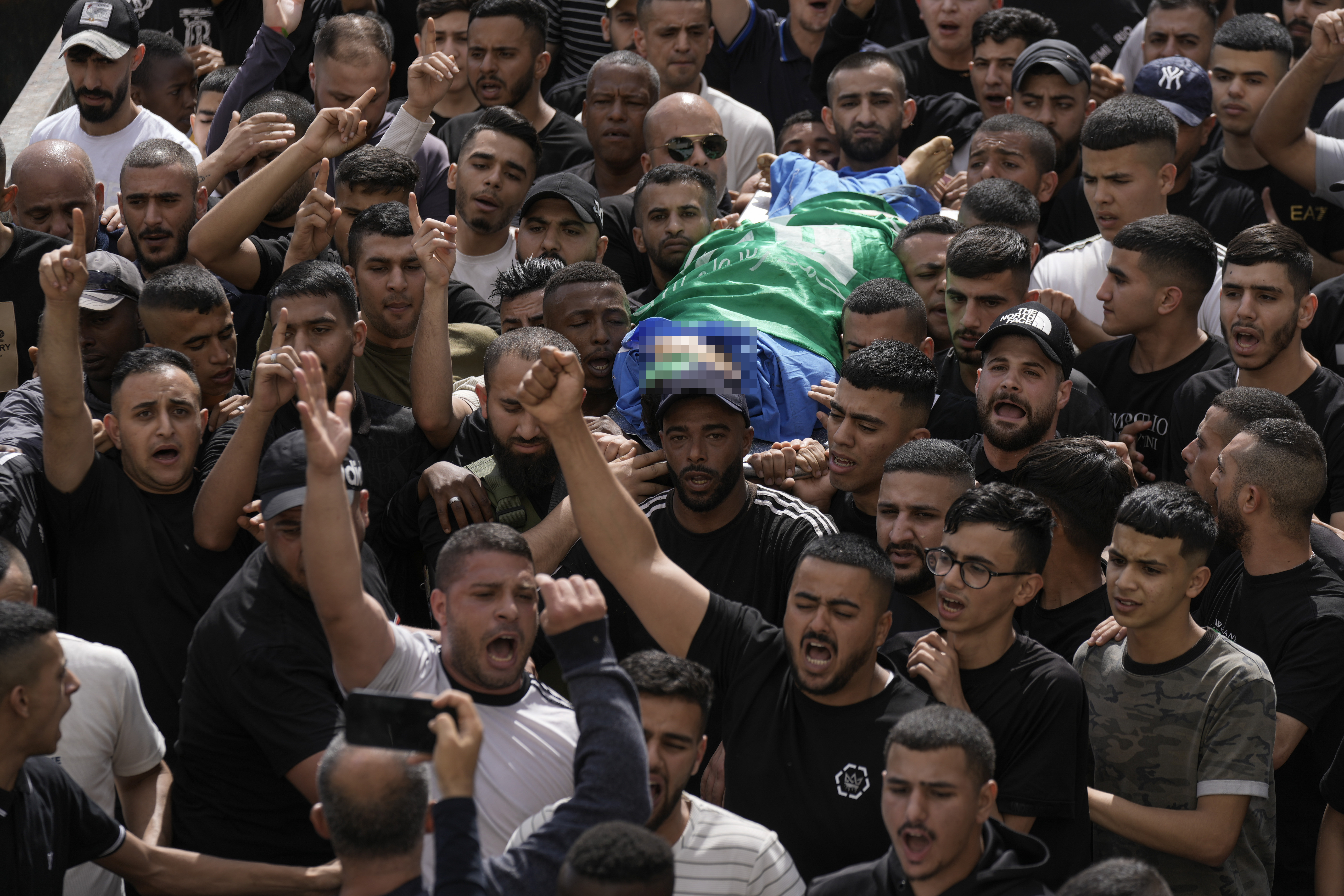 Palestinians carry the body of militant Hamza Kharyoush in the Nur Shams refugee camp near the city of Tulkarem, in the occupied West Bank.