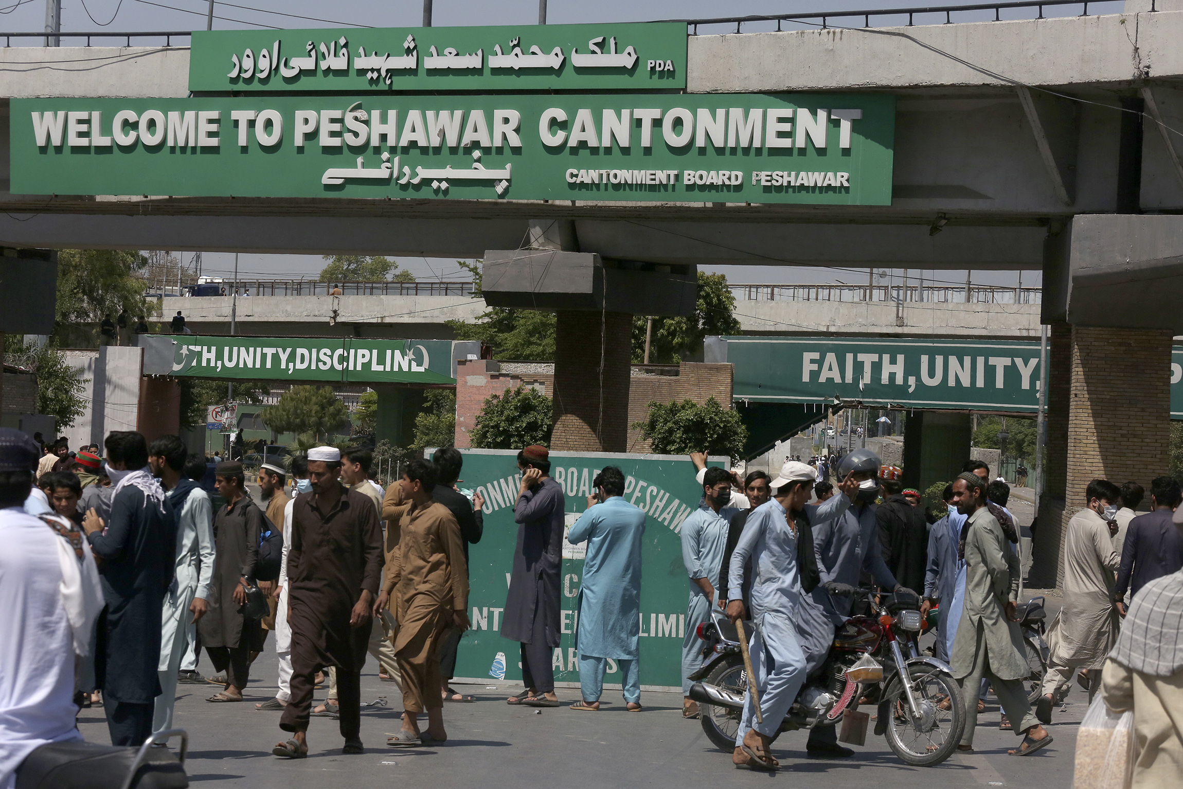 Supporters of Pakistan's former Prime Minister Imran Khan block a road as protest against the arrest of their leader, in Peshawar, Pakistan
