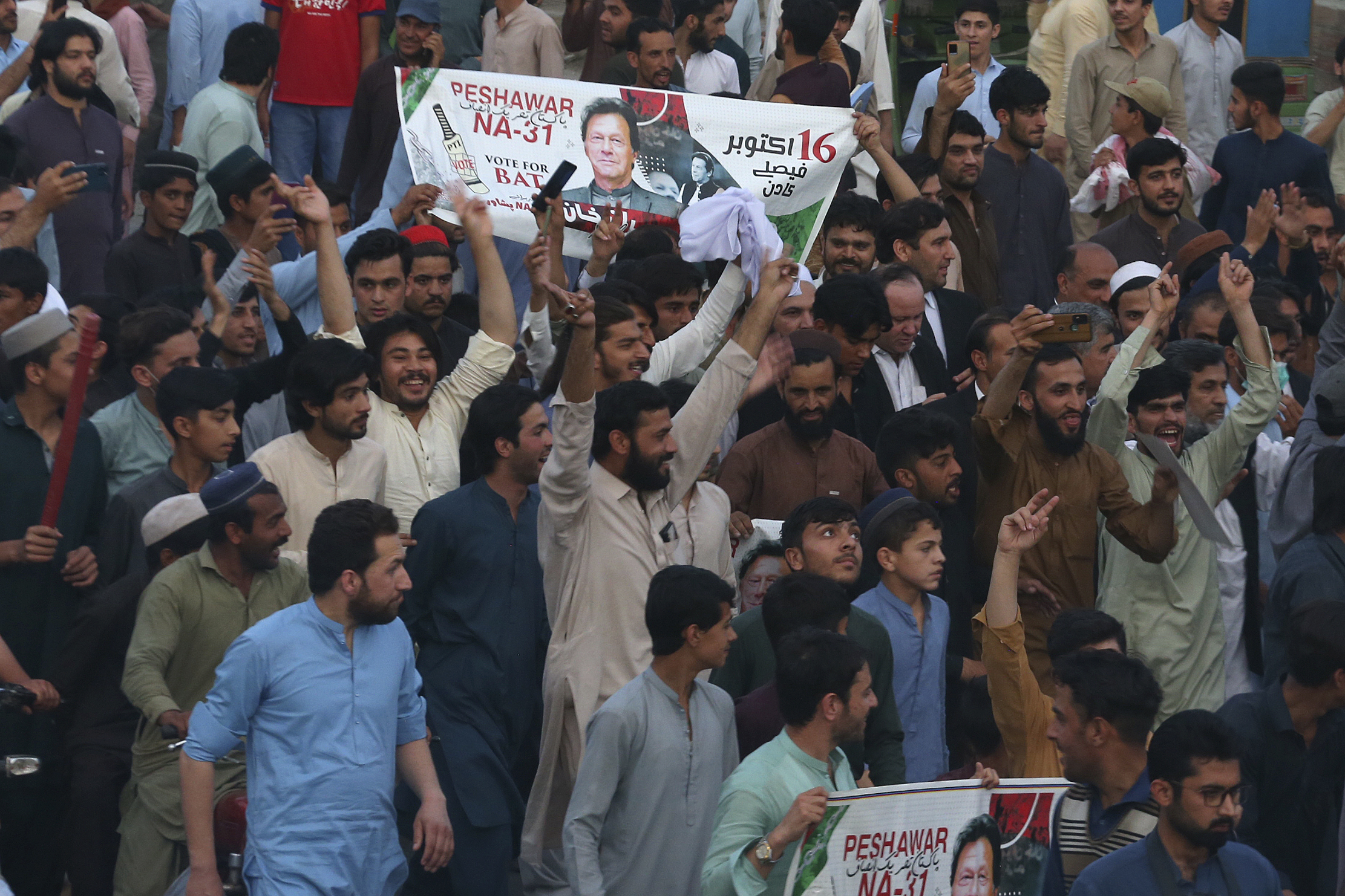 Supporters of Pakistan's former Prime Minister Imran Khan celebrate after Supreme Court decision, in Peshawar, Pakistan, Thursday, May 11, 2023. Pakistan’s Supreme Court has ordered the release of Khan, whose arrest earlier this week sparked a wave of violence across the country by his supporters. (AP Photo/Muhammad Sajjad)