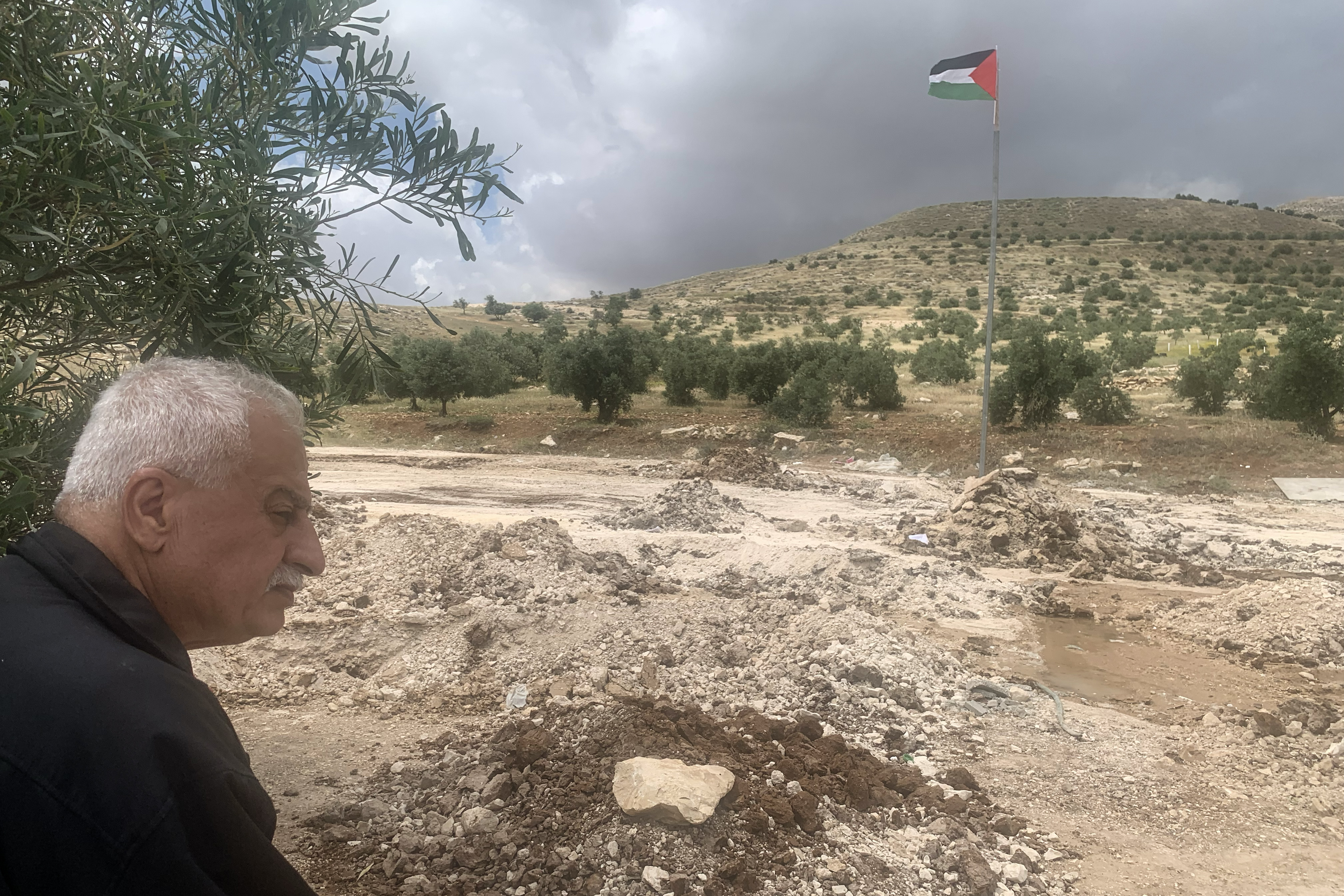 Musa Salah looking at razed land