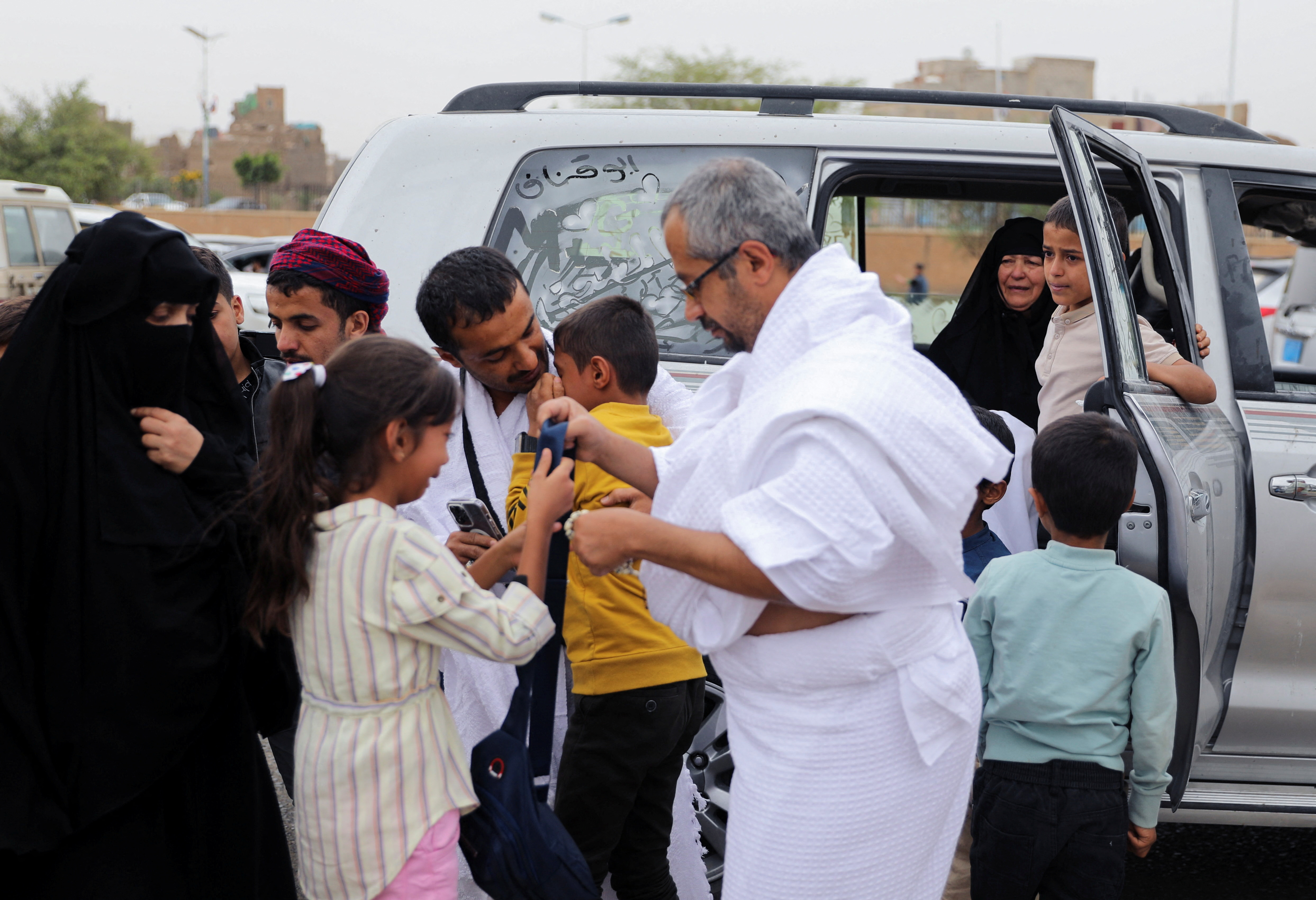 People bid farewell to pilgrims who will board a flight to Saudi Arabia for Islam's annual Haj pilgrimage from the Houthi-controlled Yemeni capital Sanaa, for the first time since war broke out eight years ago, in Yemen June 17, 2023. REUTERS/Khaled Abdullah