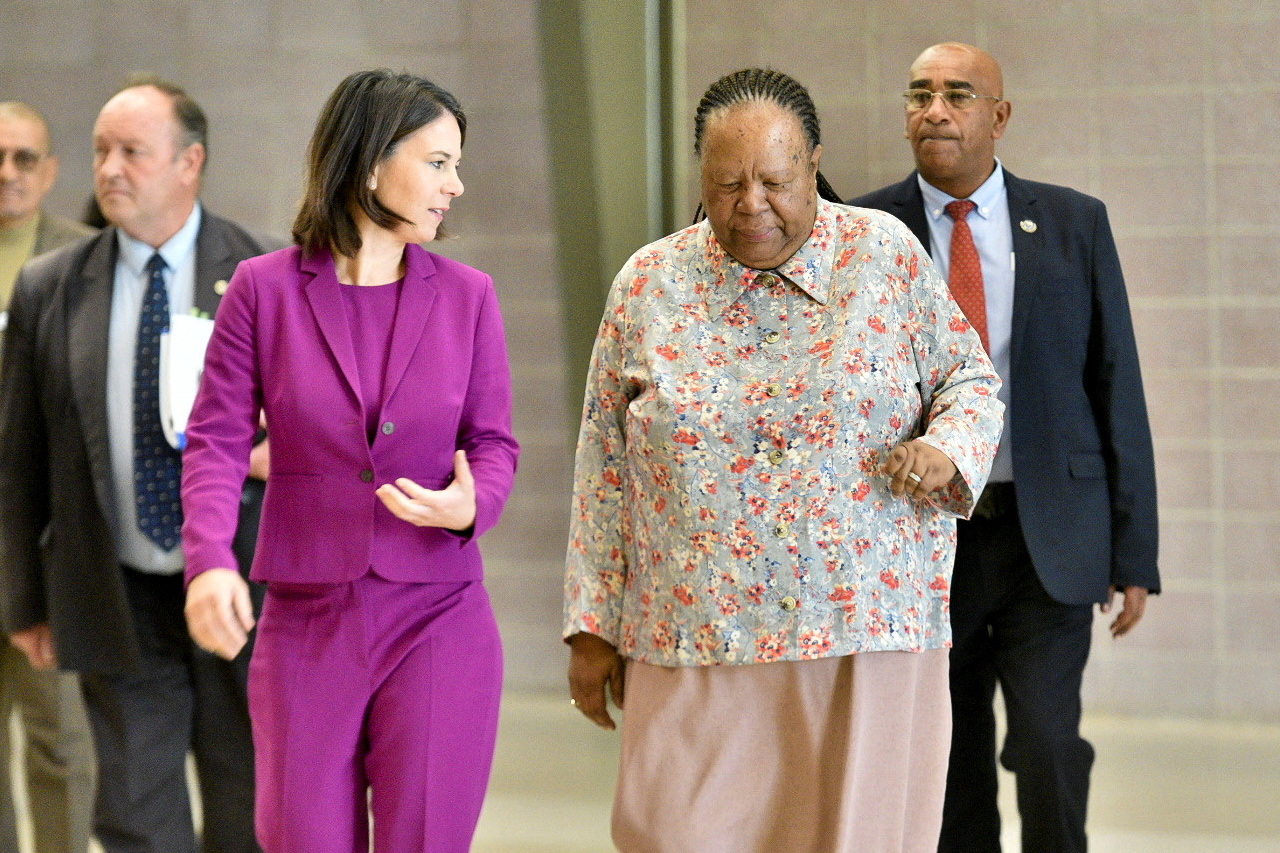 Germany's Foreign Minister Annalena Baerbock walks with South Africa's Foreign Minister Naledi Pandor, ahead of the South Africa-Germany Bi-National Commission in Pretoria, South Africa