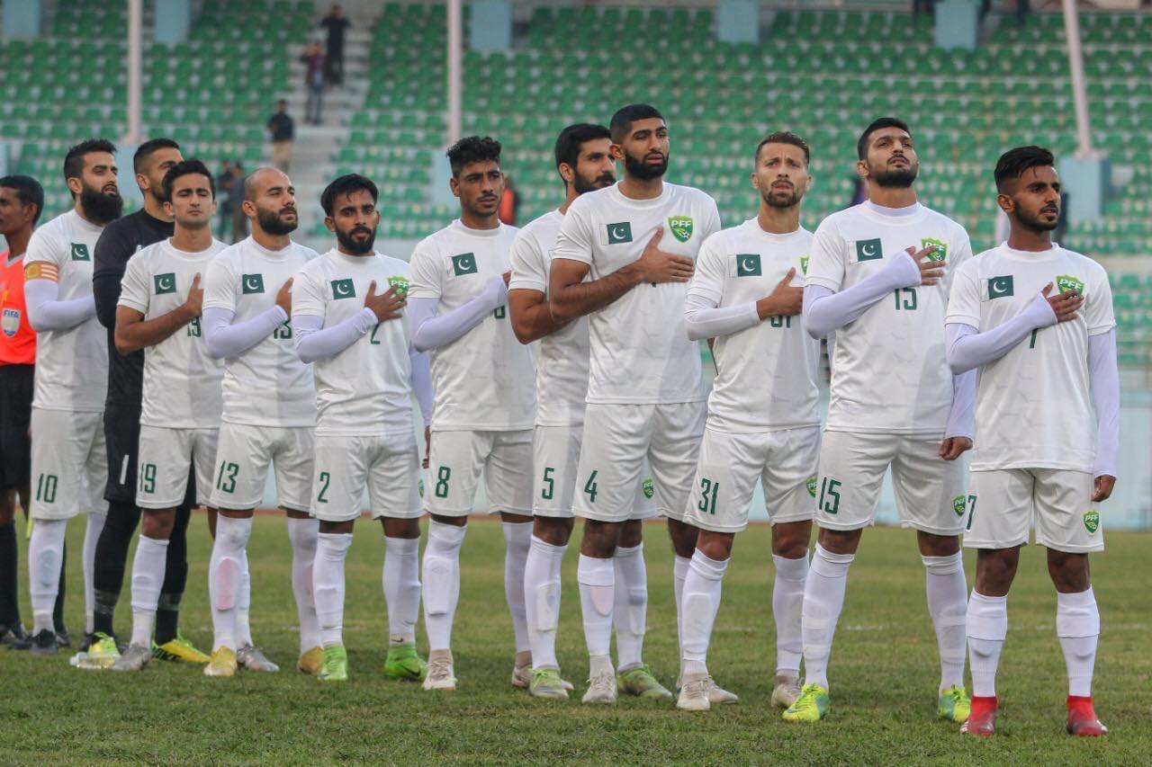 Pakistan's football team line up before a match to sign the national anthem