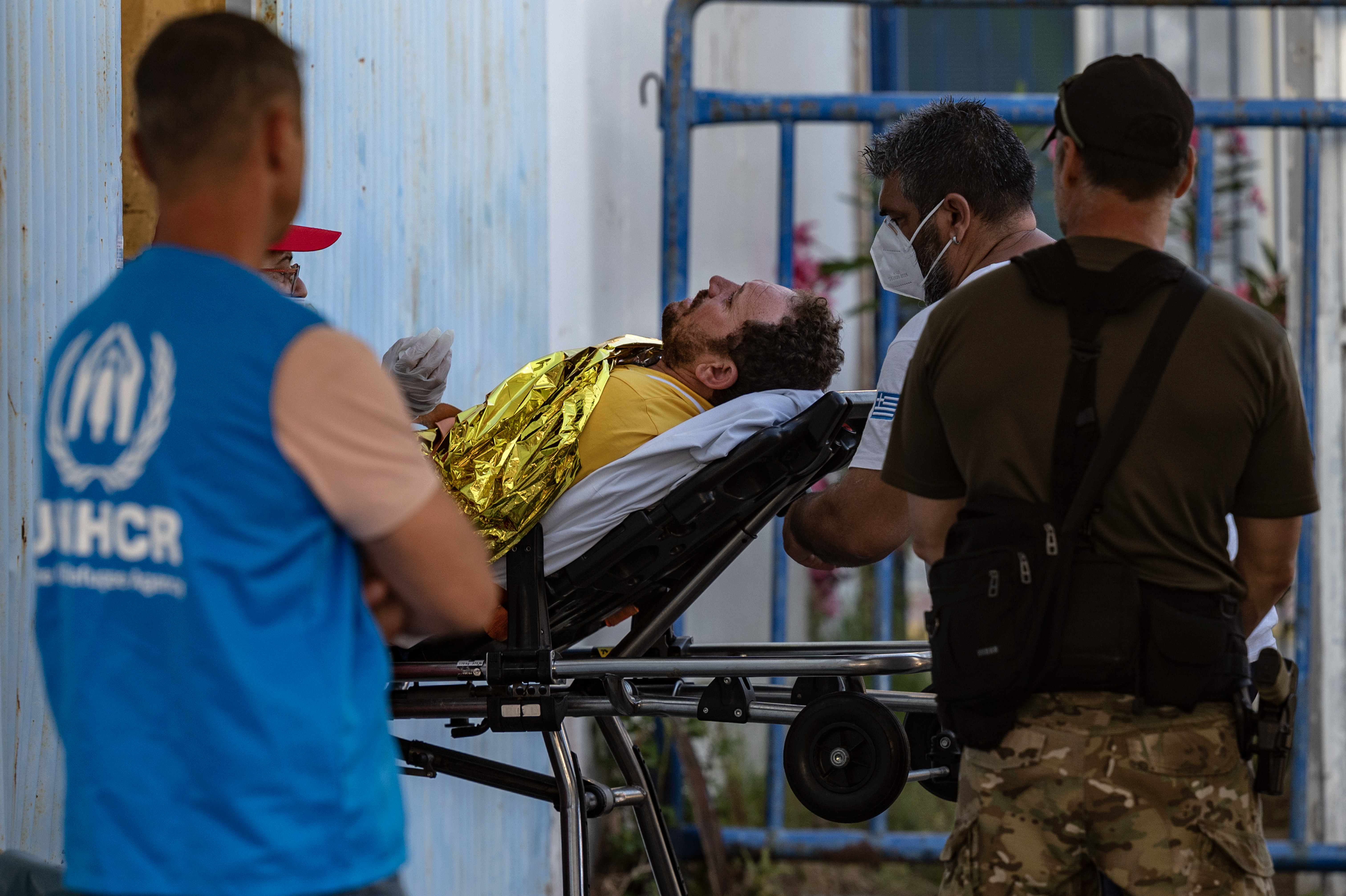 Medical staffs carry a survivor on a stretcher outside a warehouse
