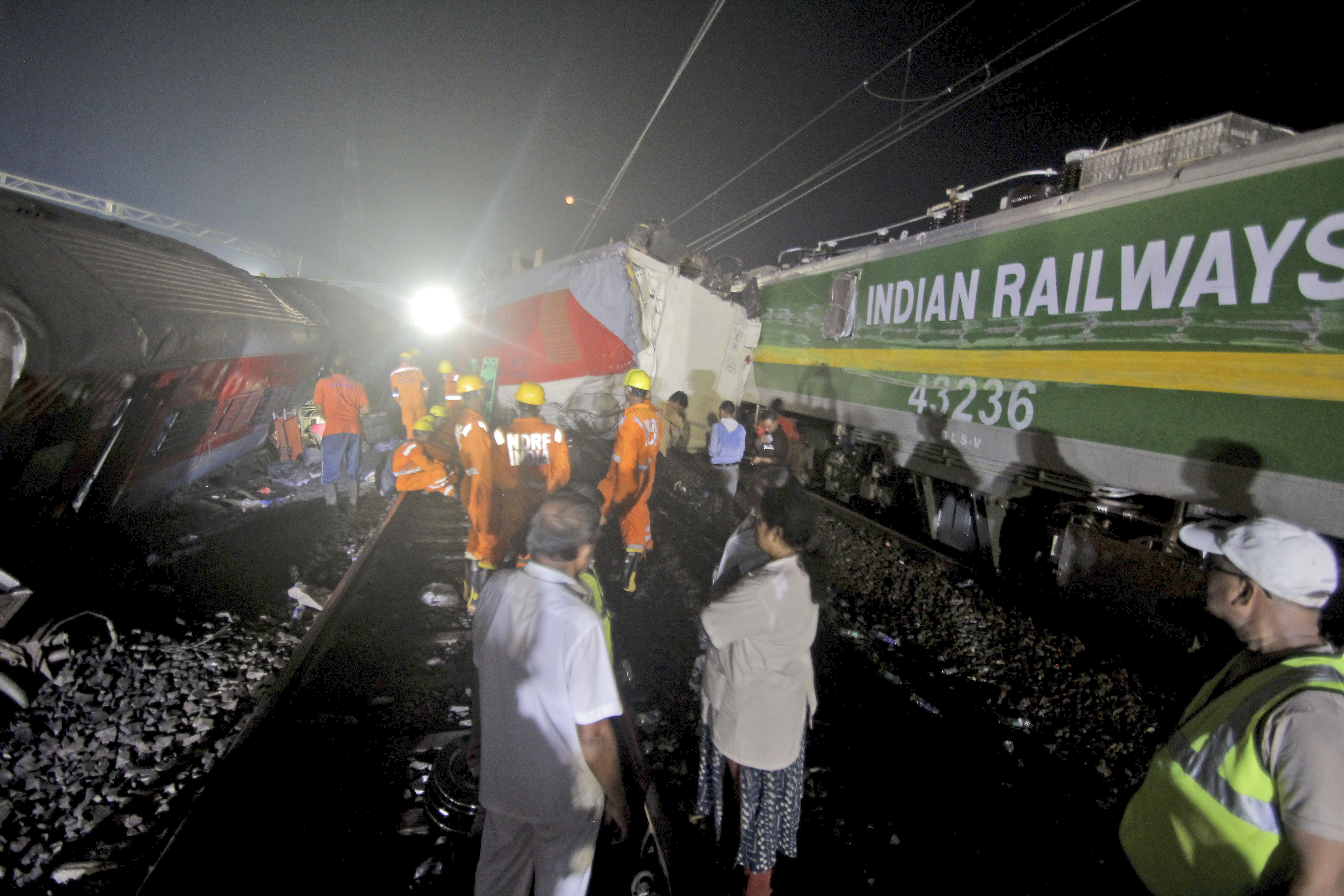 Rescuers work at the site of passenger trains accident in Balasore district