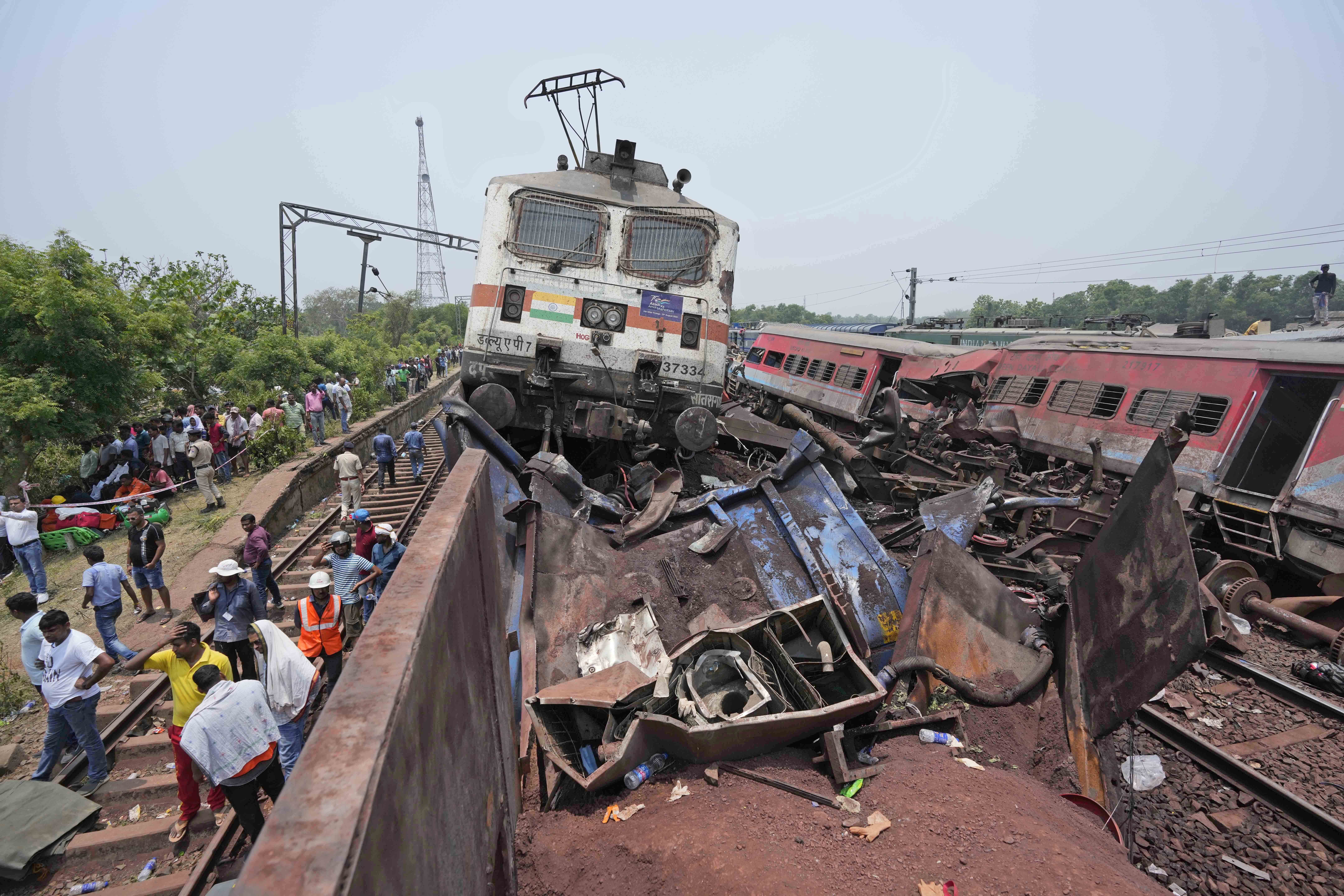 Rescuers work at the site of passenger trains that derailed in Balasore district