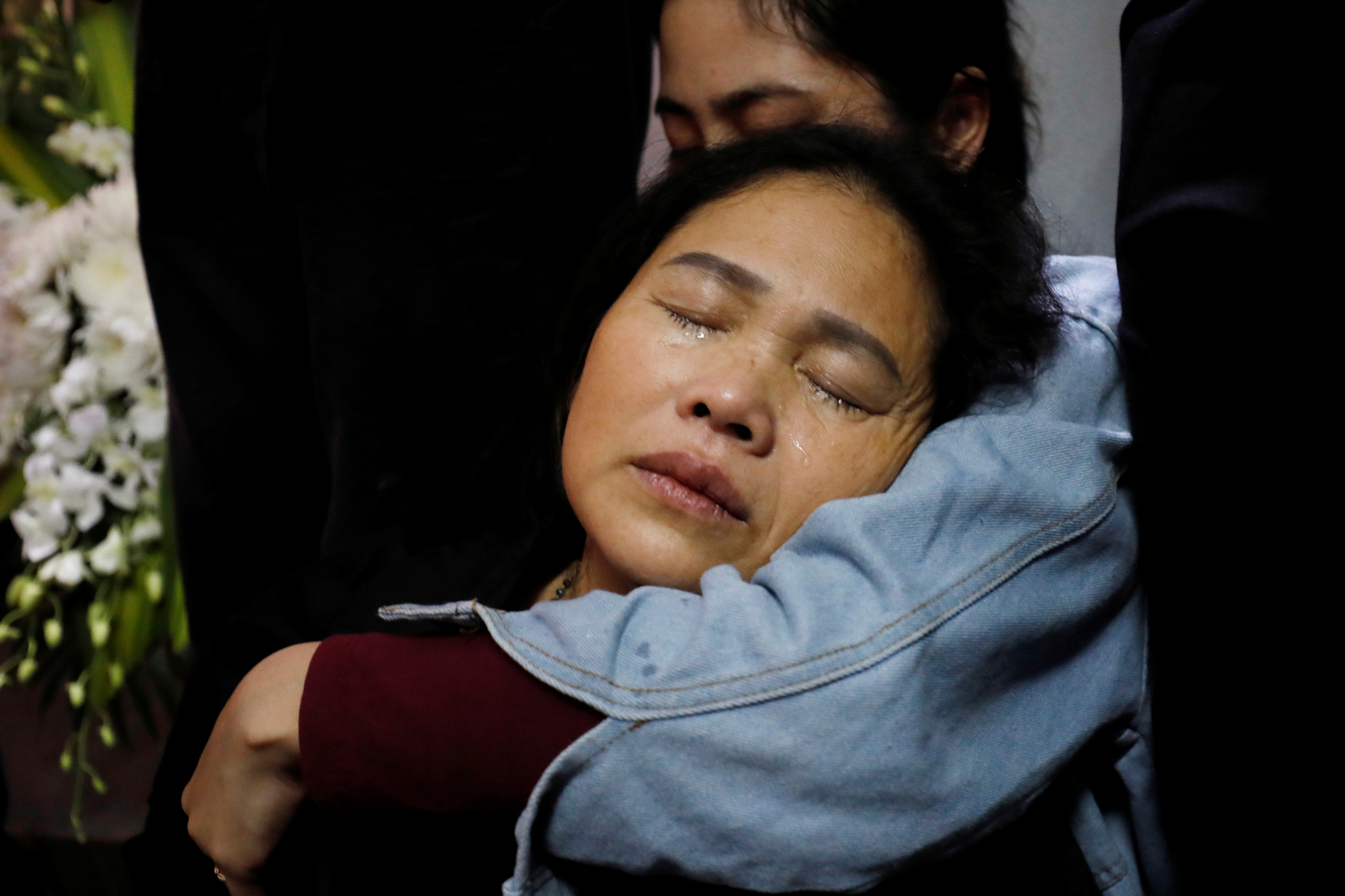 Anna Hoang Thi Ai, a mother of John Hoang Van Tiep and a victim who was found dead in the back of a British truck last month, cries next to his body in Nghe An province, Vietnam November 27, 2019. REUTERS/Kham