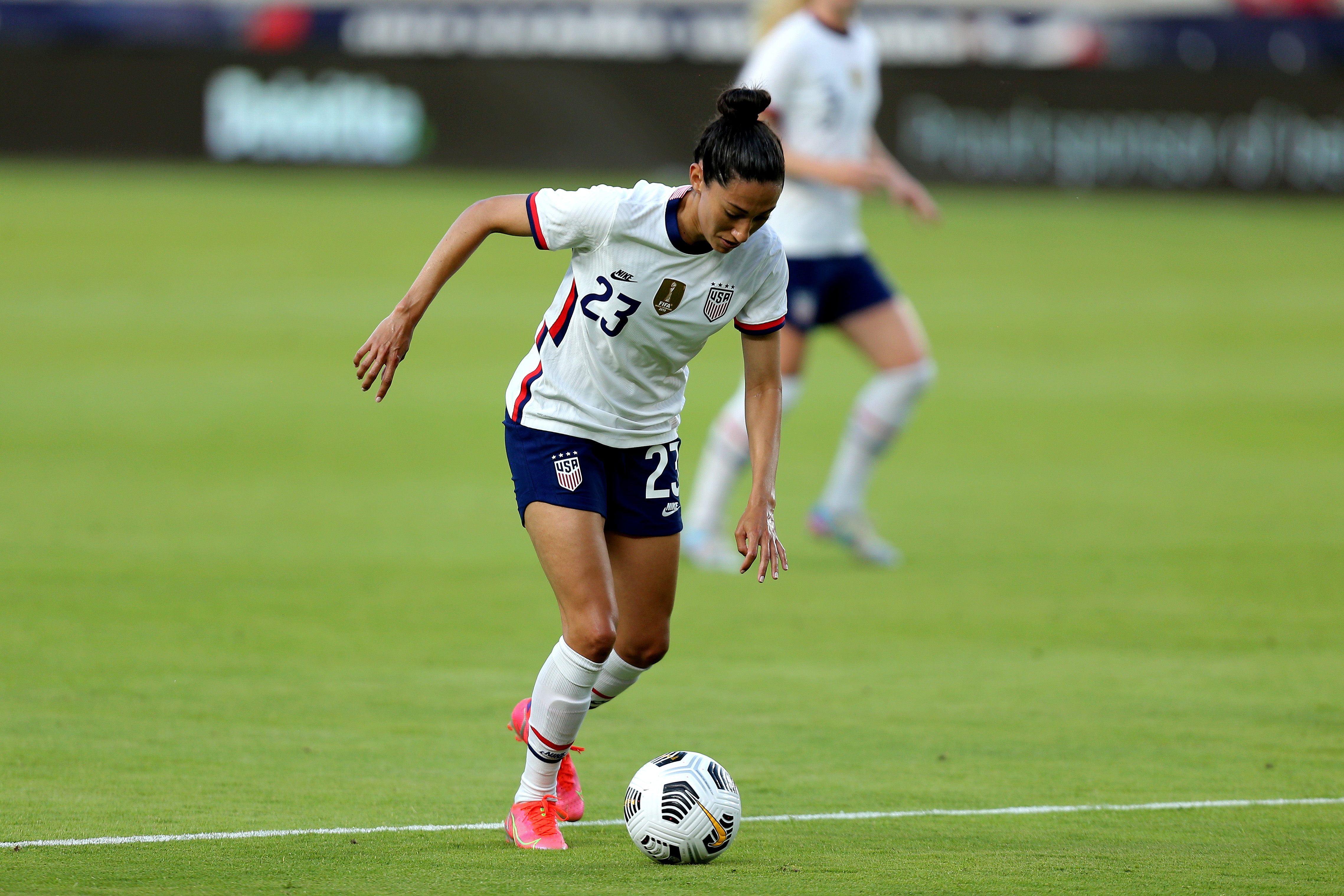 US forward Christen Press controls a football