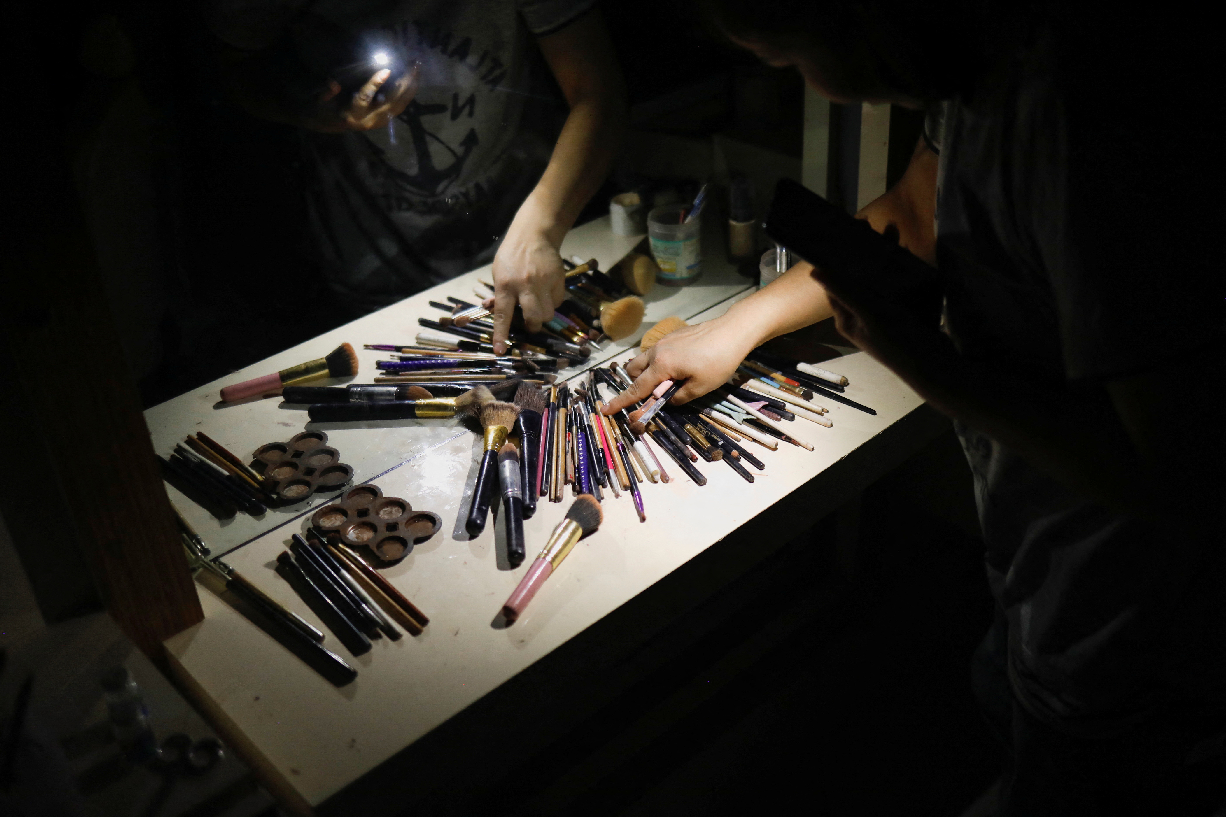 An Afghan beautician collects equipment in a beauty salon in Kabul, Afghanistan