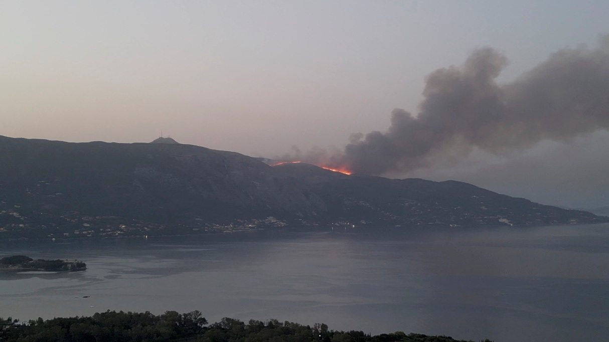 Plumes of smoke rise from a wildfire on the island of Corfu