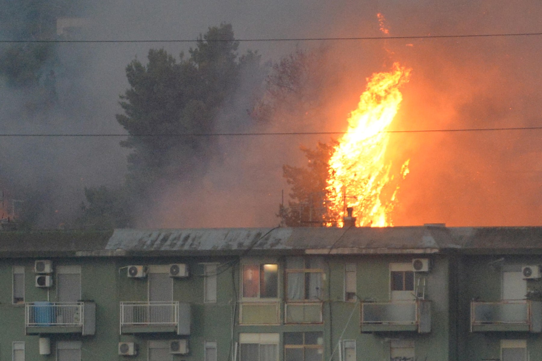 a vast fire spreading on hills in the area of Monte Grifone and the town of Ciaculli around Palermo, Sicily