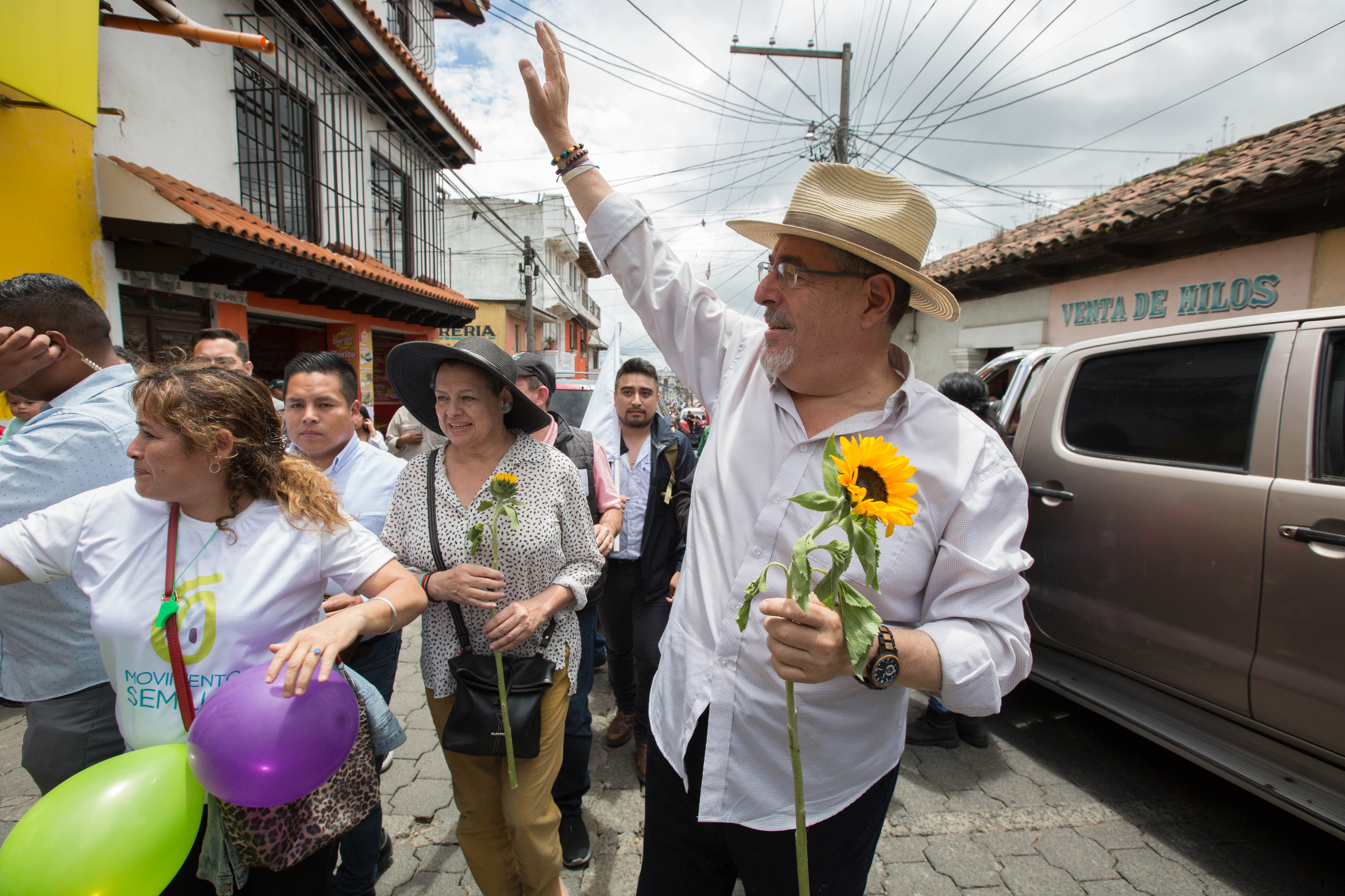 Bernardo Arevalo, right, greets supporters in the community of Santa Maria de Jesus during a campaign stop on July 16 [Jeff Abbott/Al Jazeera]
