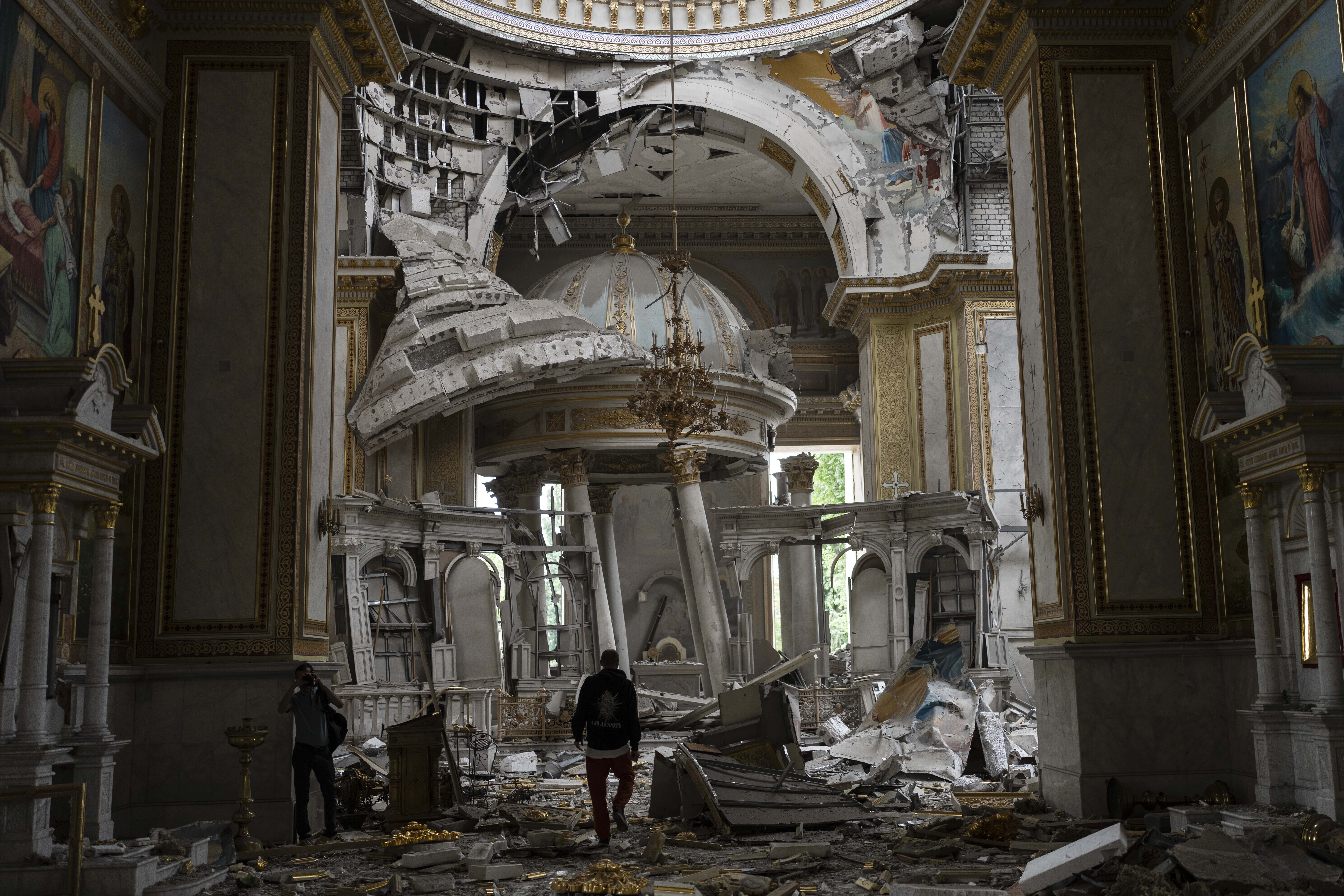Church personnel inspect damages inside the Odesa Transfiguration Cathedral in Odesa, Ukraine, on Sunday, July 23, 2023.