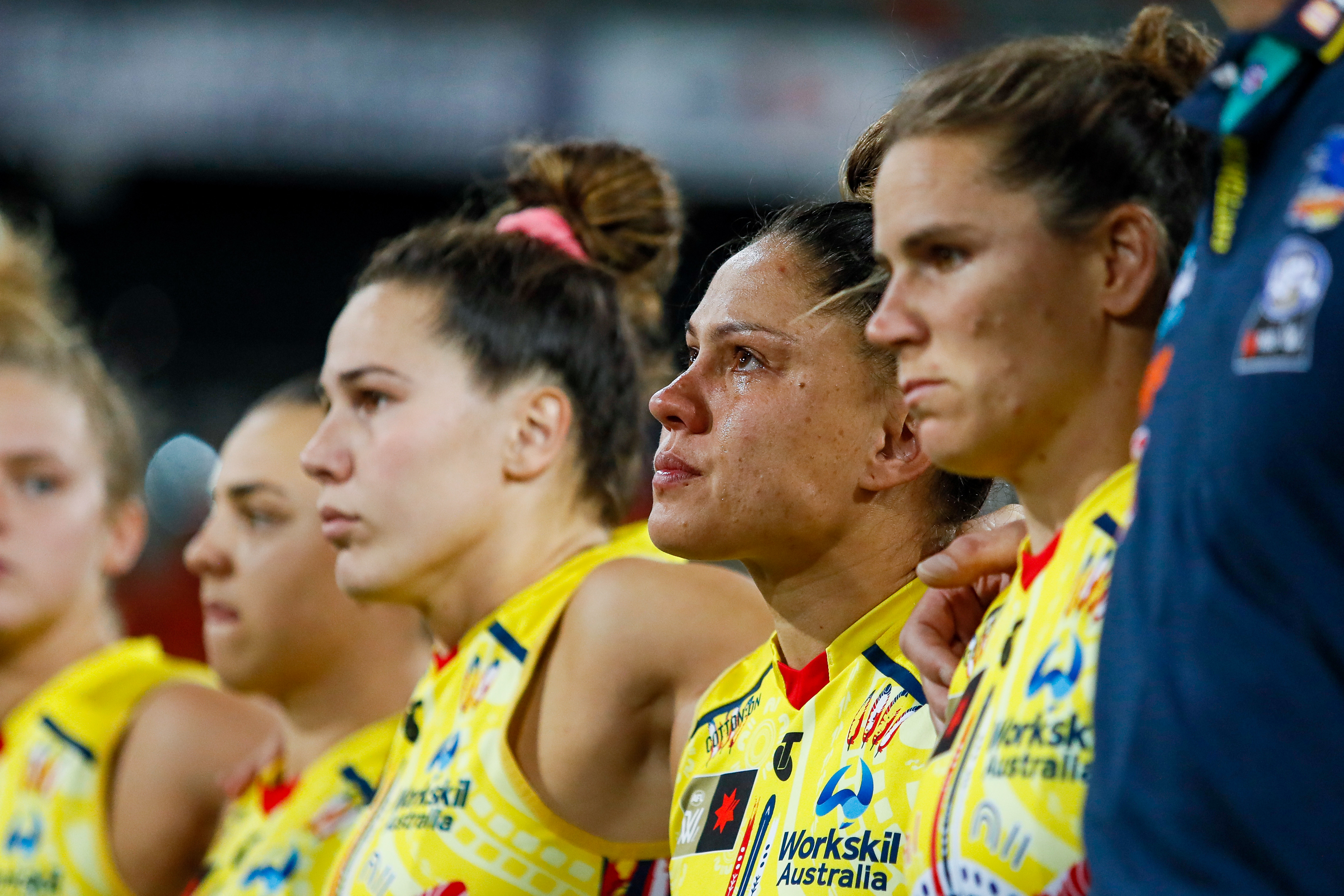 Stevie-Lee Thompson of the Crows is seen getting emotional during a moments silence for former teammate Heather Anderson who passed away earlier in the week before the 2022 S7 AFLW First Preliminary Final match between the Brisbane Lions and the Adelaide Crows at Metricon Stadium on November 18, 2022 i