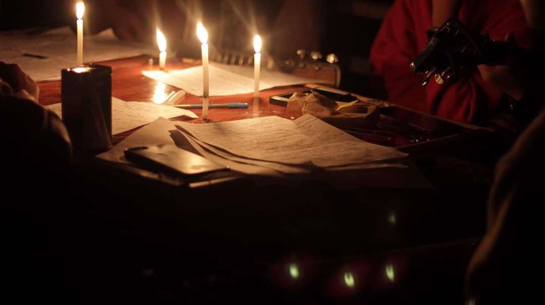 Students gathered around candles amid a blackout