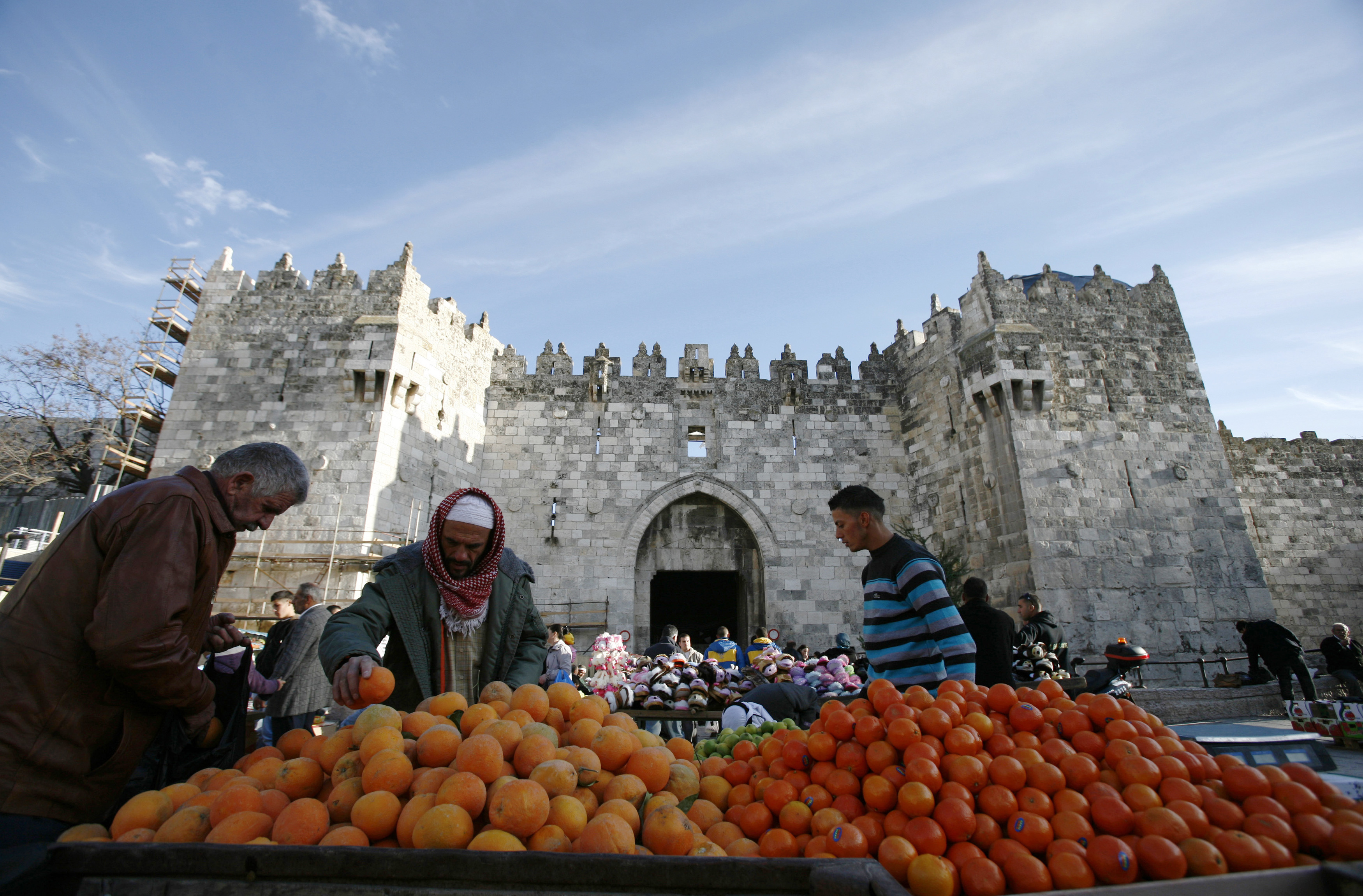 Palestinians select fruit at a stall near Damascus Gate