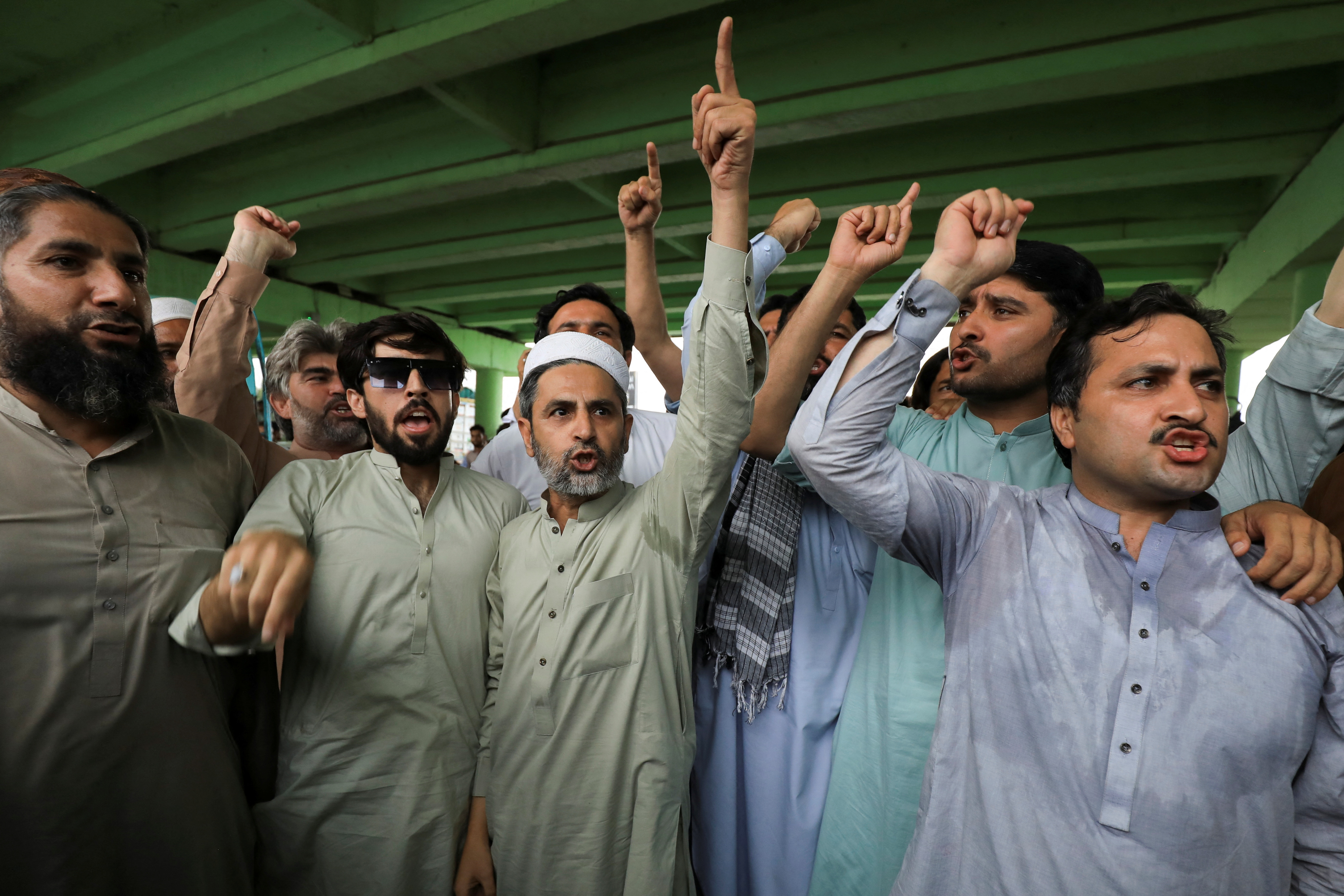 Supporter chant slogans as they gather for a protest following the arrest of Pakistan's former Prime Minister Imran Khan